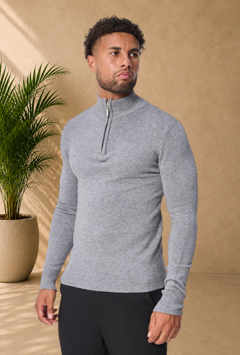Stayin grey knit sweater with a high zip-up collar worn by a male model for a sophisticated winter look.