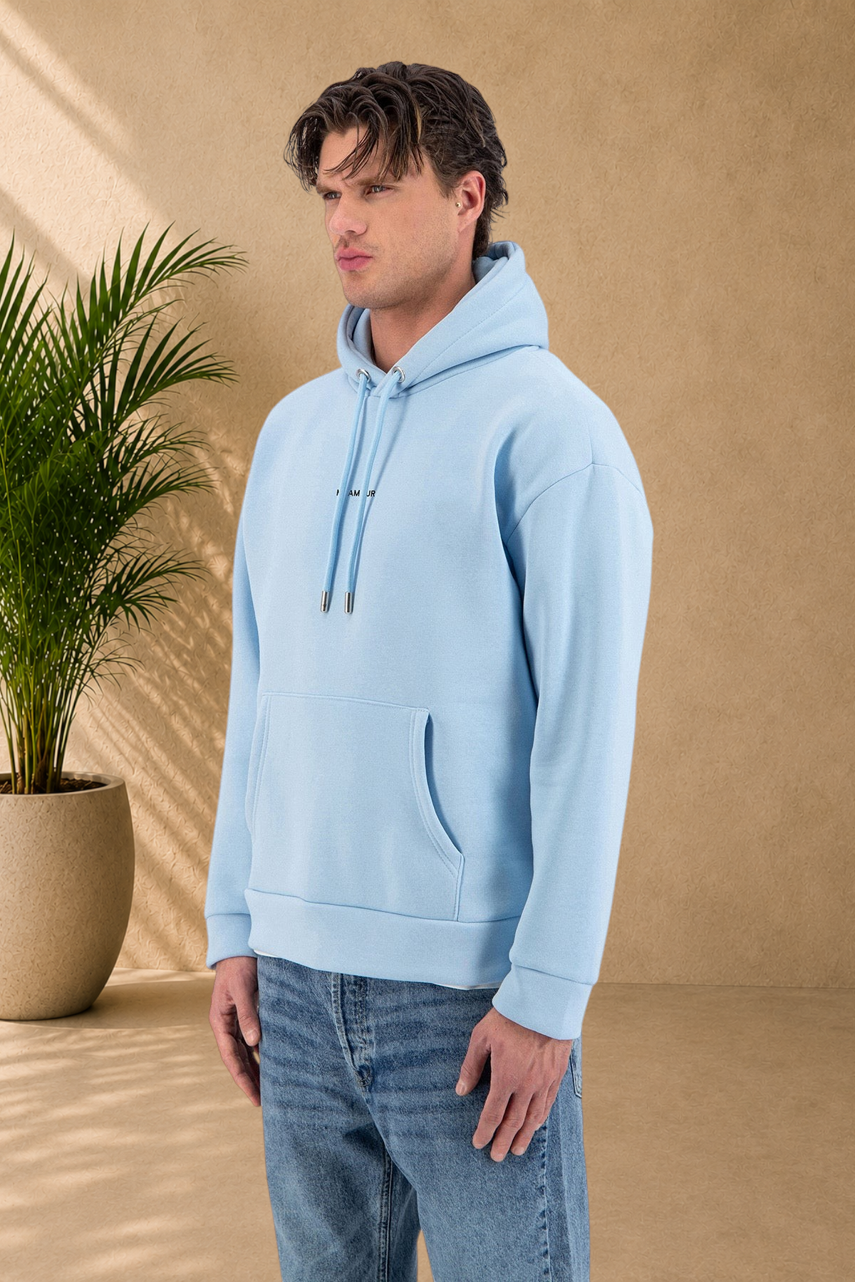 Stayin light blue quilted hoodie with drawstring hood and front pocket worn by a male model