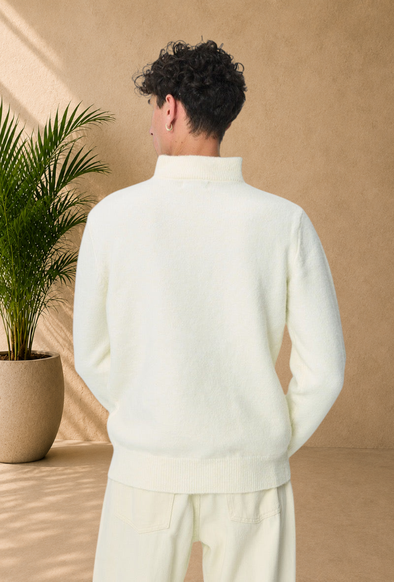 Back view of a man wearing a Stayin white cable knit sweater with a high zip-up collar, isolated on white background.