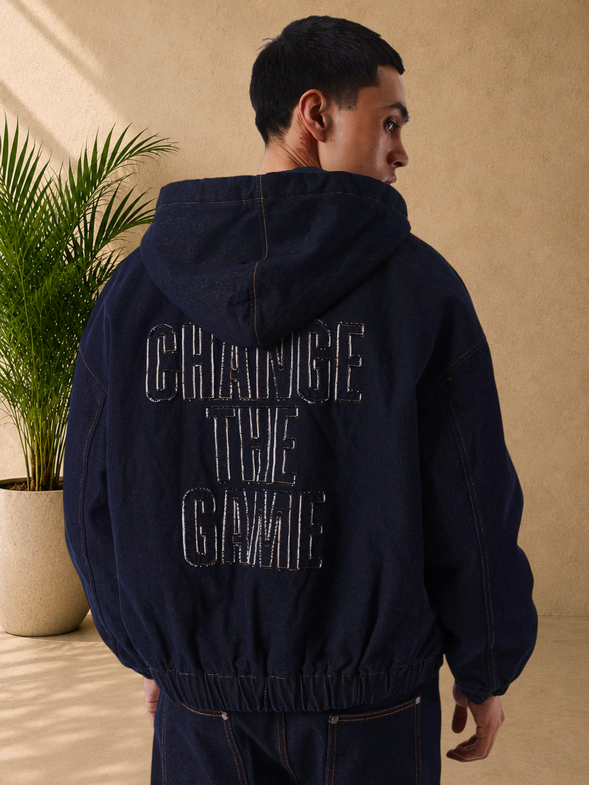 Stayin boxy dark denim zip-up hoodie with Change The Game embroidery on the back worn by a model