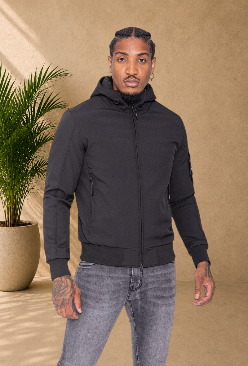 Stayin black hooded windbreaker jacket with a slim fit, worn by a male model against a white background