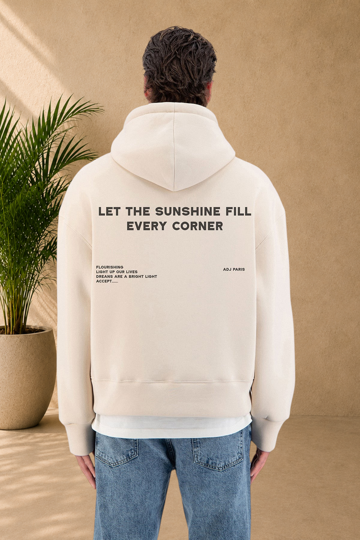Stayin beige quilted hoodie with back graphic print worn by a model against a white background