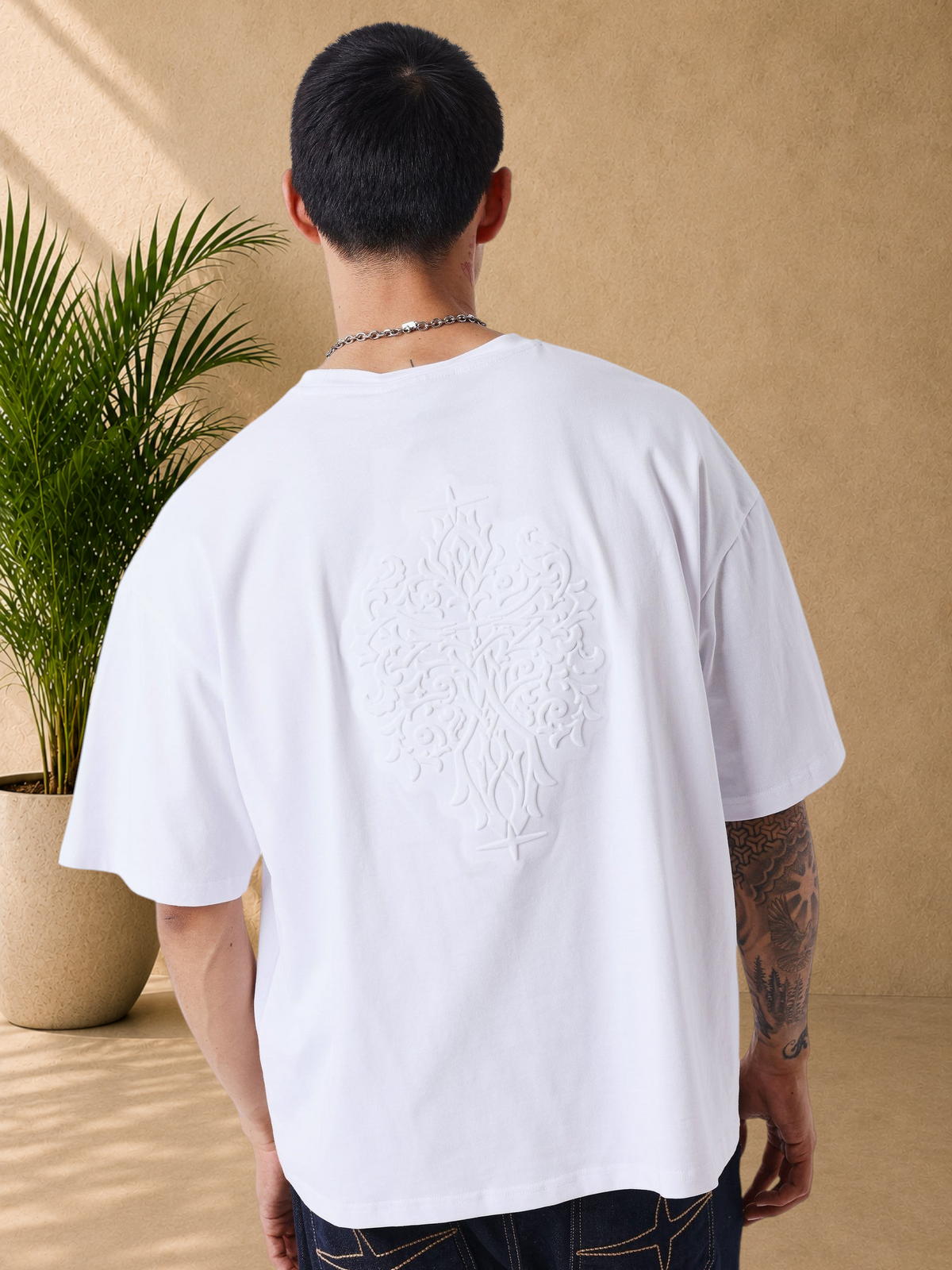 Stayin white boxy fit cotton t-shirt with large tonal embossed motif on the back, worn by a model