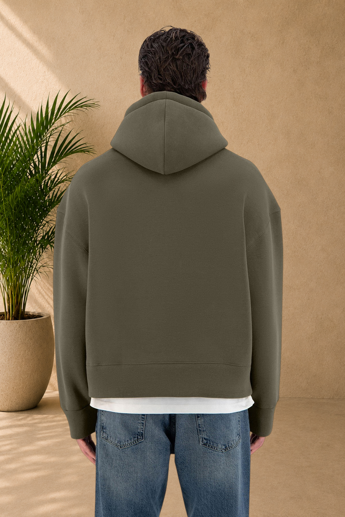 Stayin khaki quilted hoodie worn by a model, back view, showing thick fabric and relaxed fit.