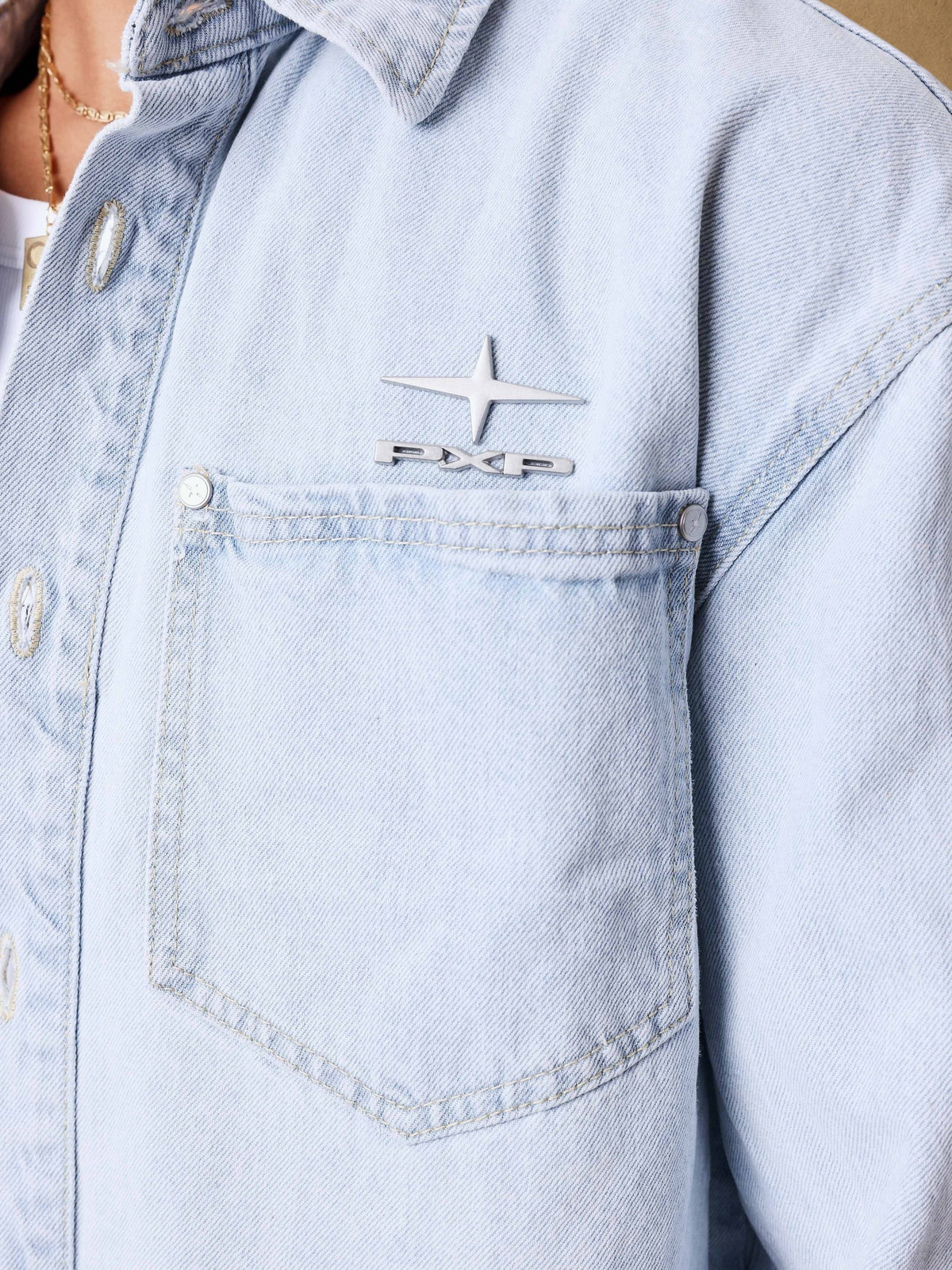 Stayin PXP light blue denim jacket with metallic logo on chest pocket and button closure