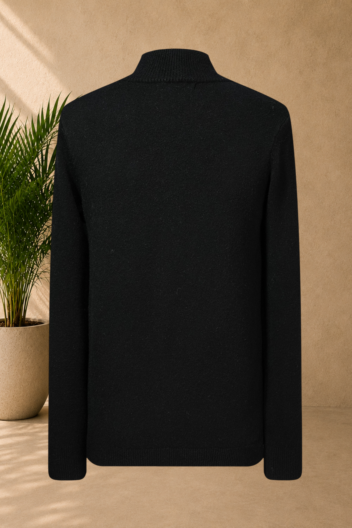 Stayin black knit sweater with a mock neck, shown from the back, featuring soft warm fabric and a straight cut.
