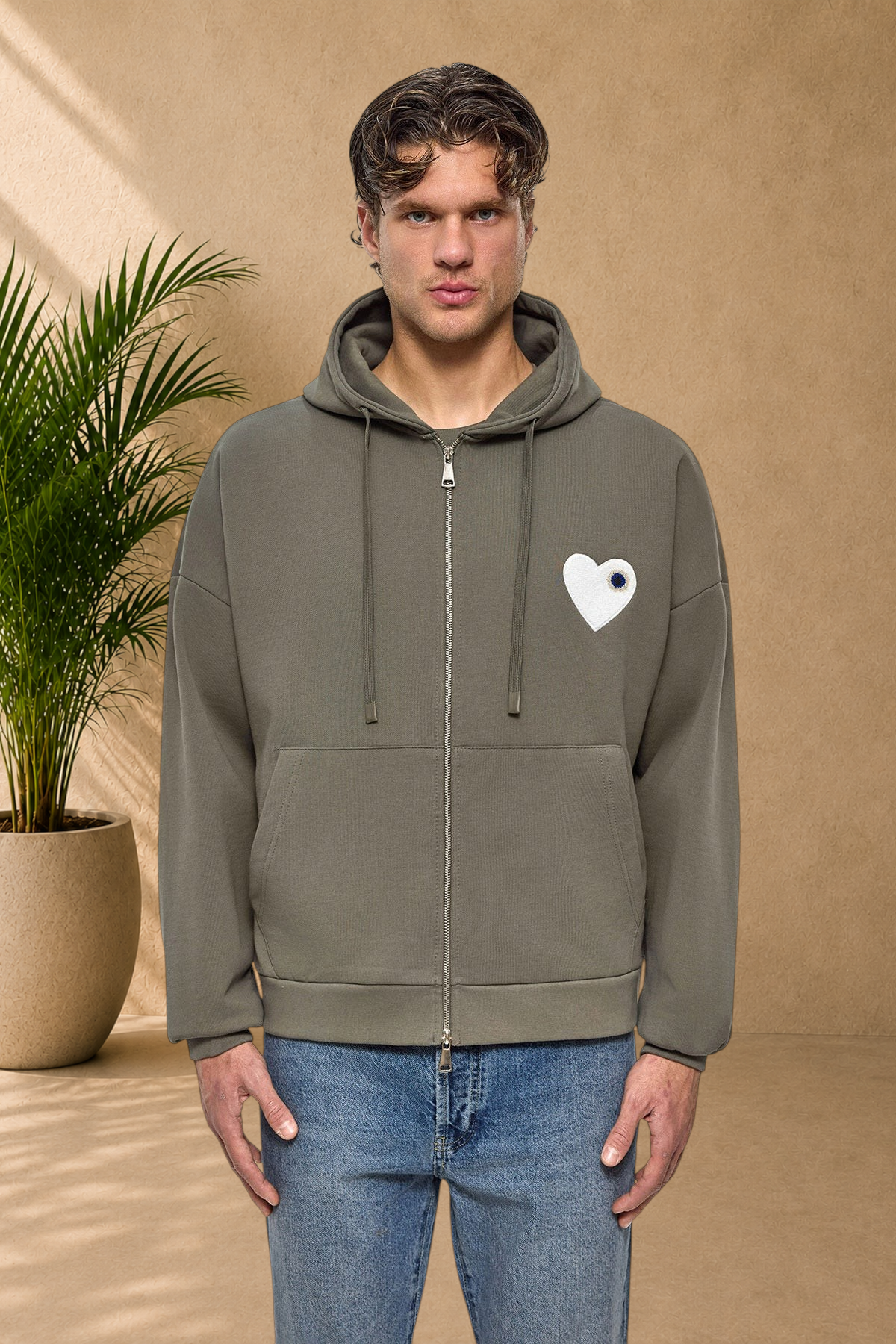 Stayin khaki quilted zip-up hoodie with a white heart patch worn by a male model