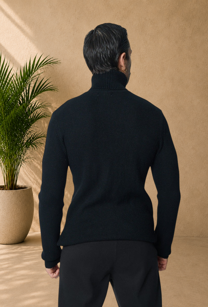 Stayin black ribbed knit turtleneck sweater worn by a man, back view against a neutral studio background