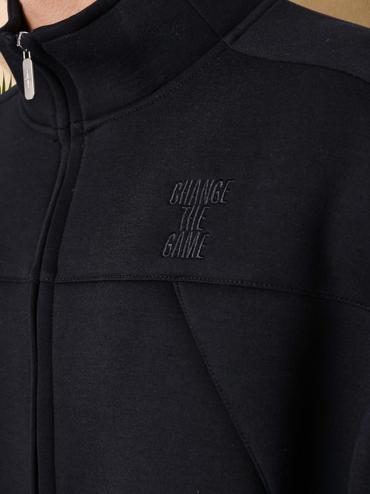 Stayin PXP black neoprene zip-up vest with high collar and Change The Game embroidery on the chest