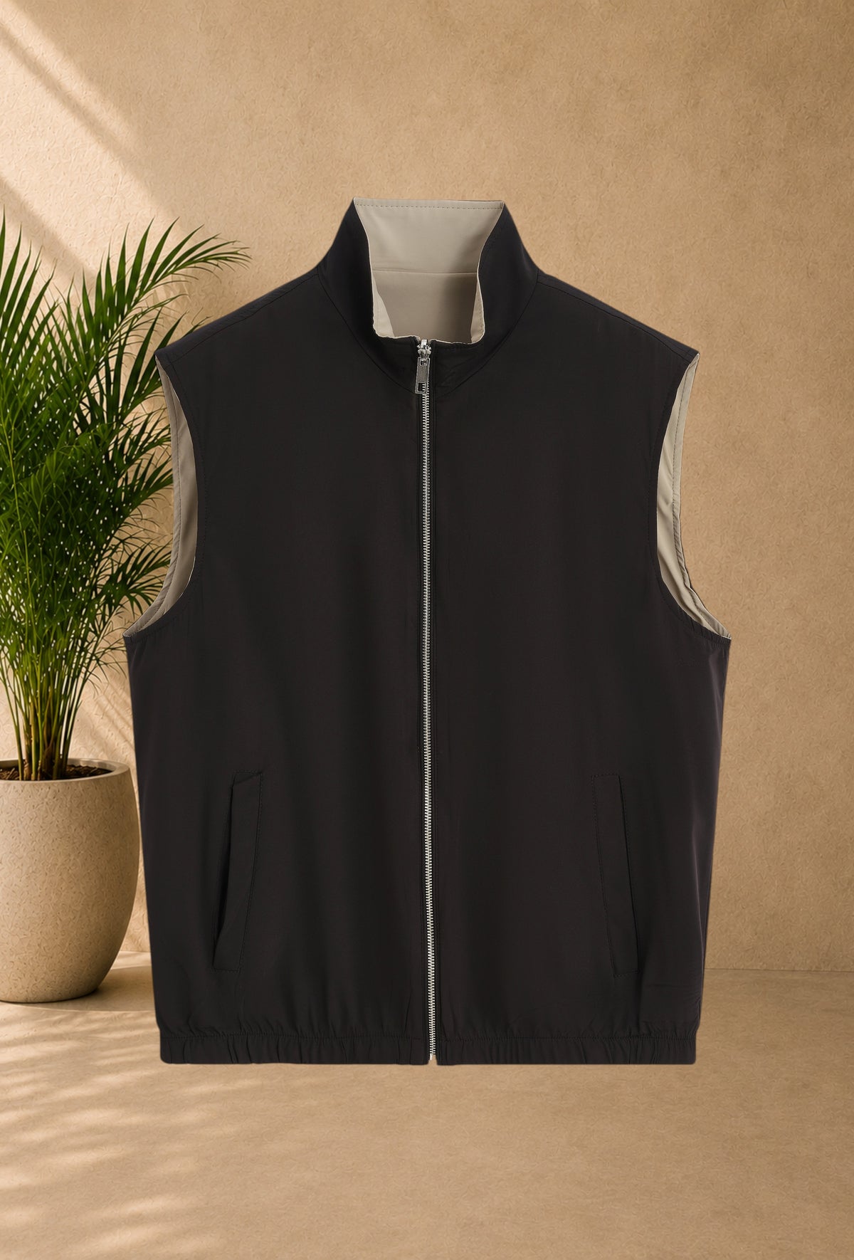 Stayin reversible sleeveless zip-up vest in black and beige with a modern straight cut and soft lining.