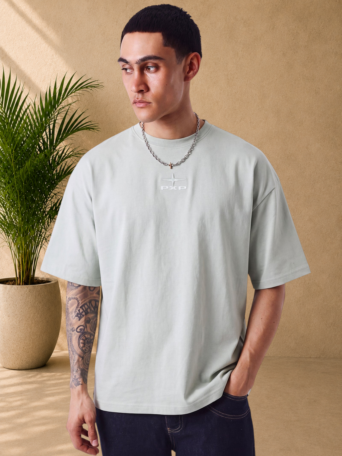 Stayin boxy fit mint green cotton t-shirt with embossed PXP logo on chest worn by a male model