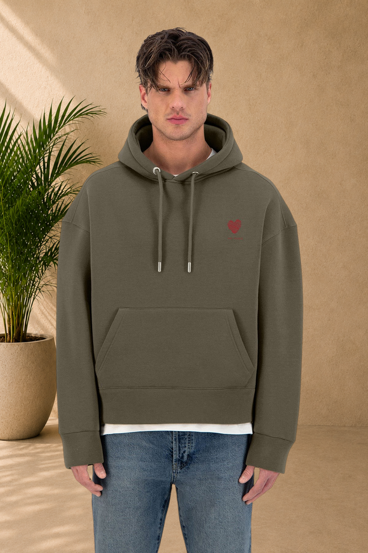 Stayin khaki quilted hoodie with a small red heart embroidery on the chest worn by a male model