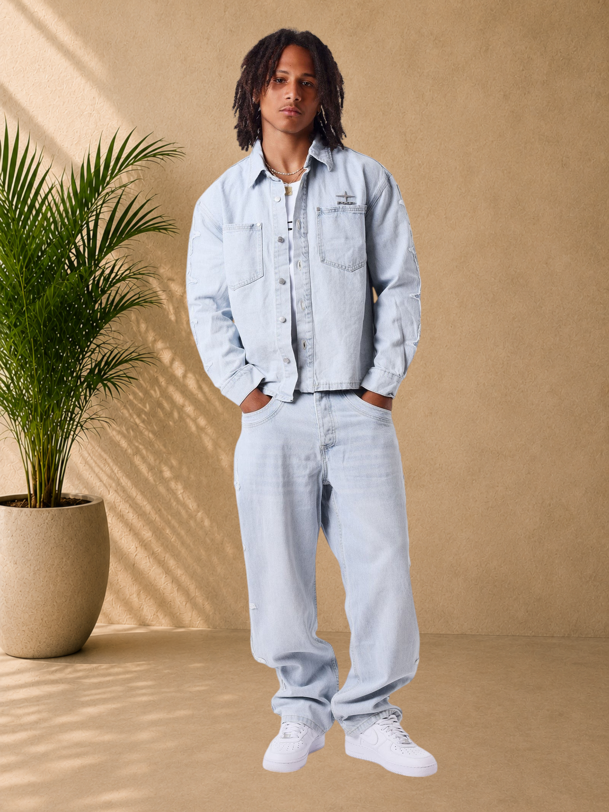 Stayin light blue loose fit denim jacket with Polaris sleeve detailing and metallic chest logo on a male model