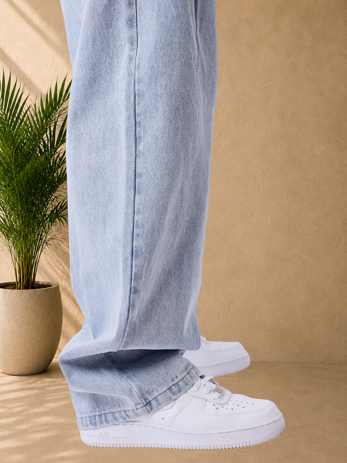 Stayin light blue loose-fit cotton blend jeans with front pleats worn with white sneakers