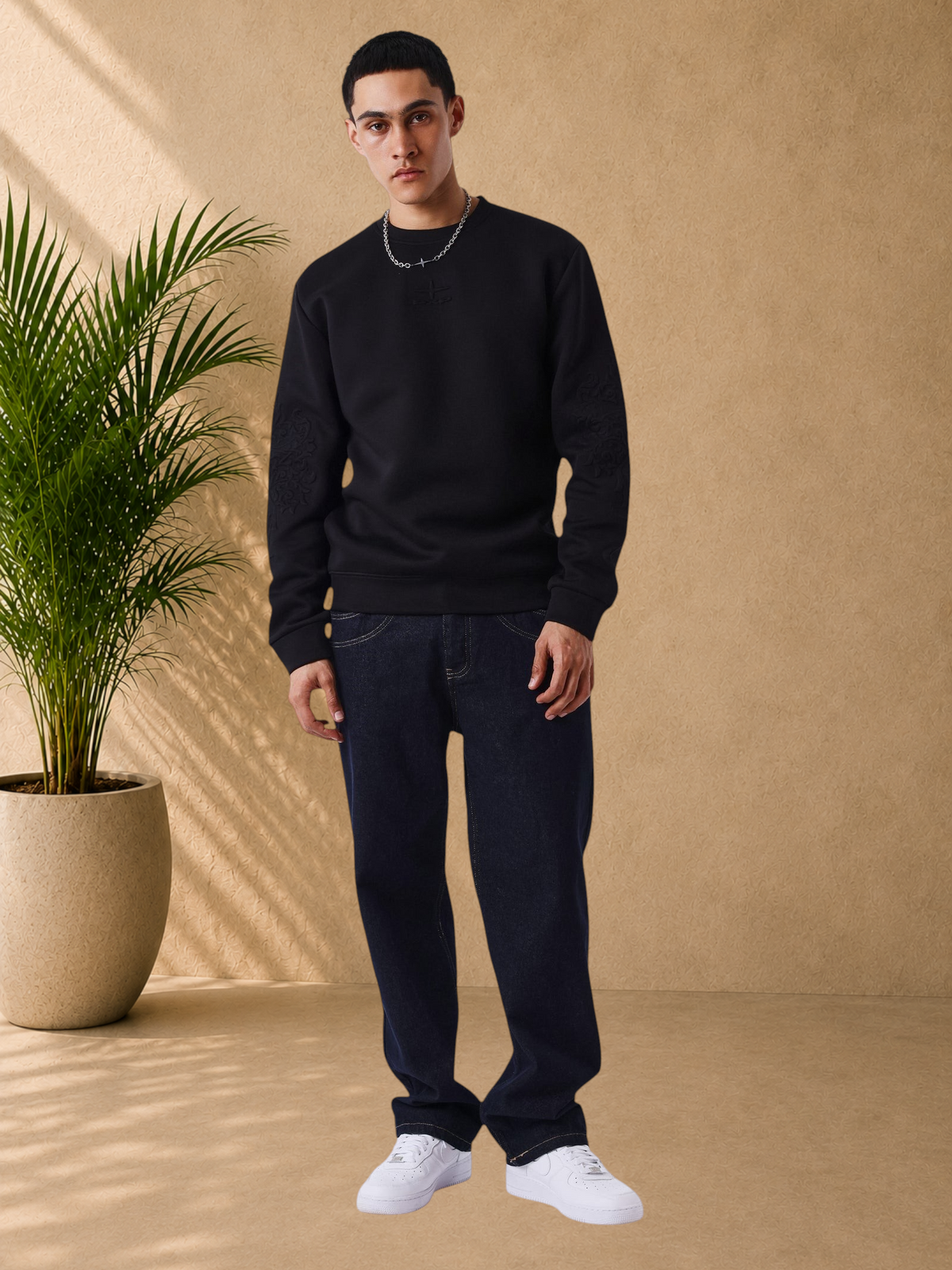 Stayin black regular fit crew neck sweatshirt with tonal embroidered logo and embossed sleeve detail on a model