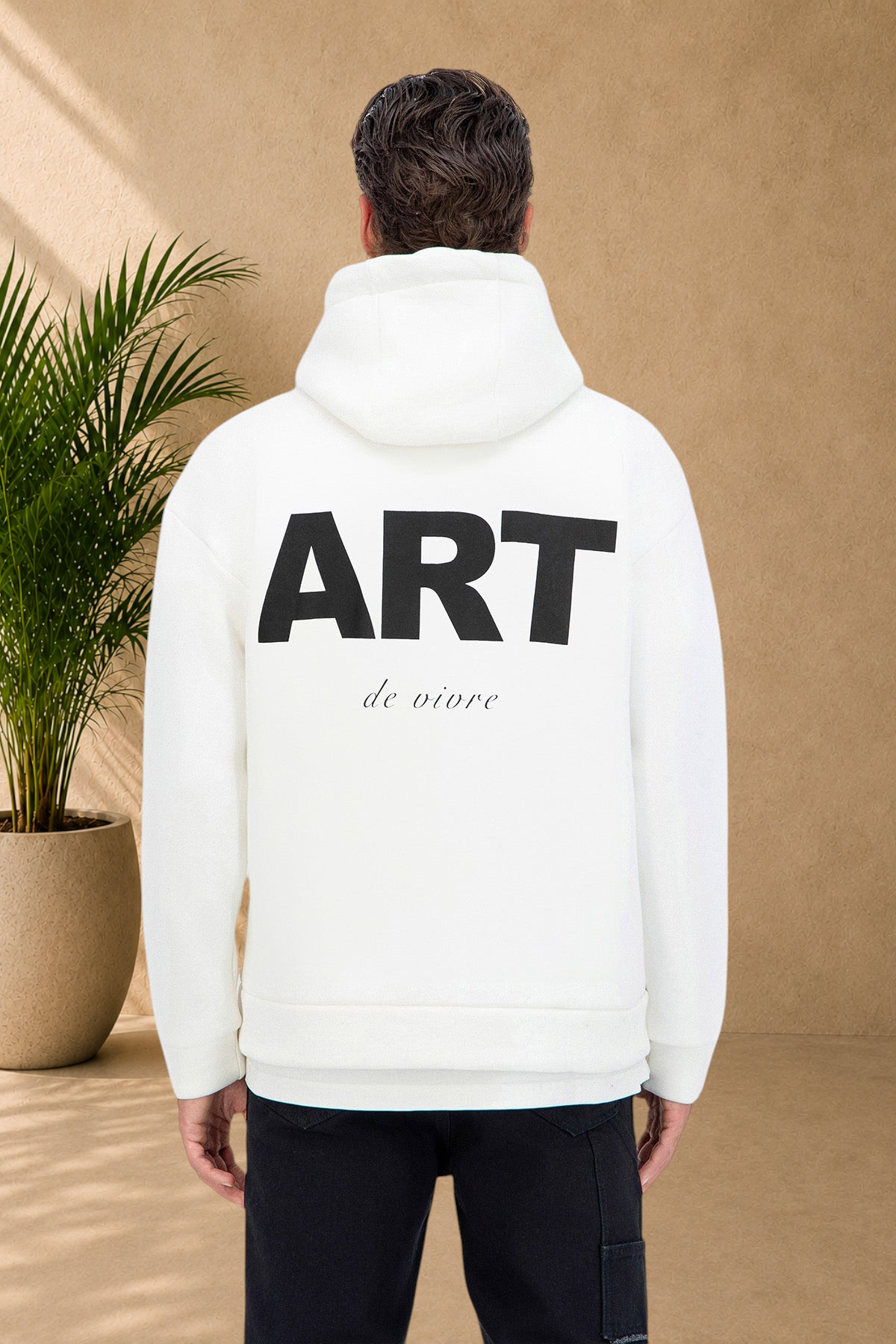 Stayin white quilted hoodie with ART graphic print on the back worn by a model in a studio setting
