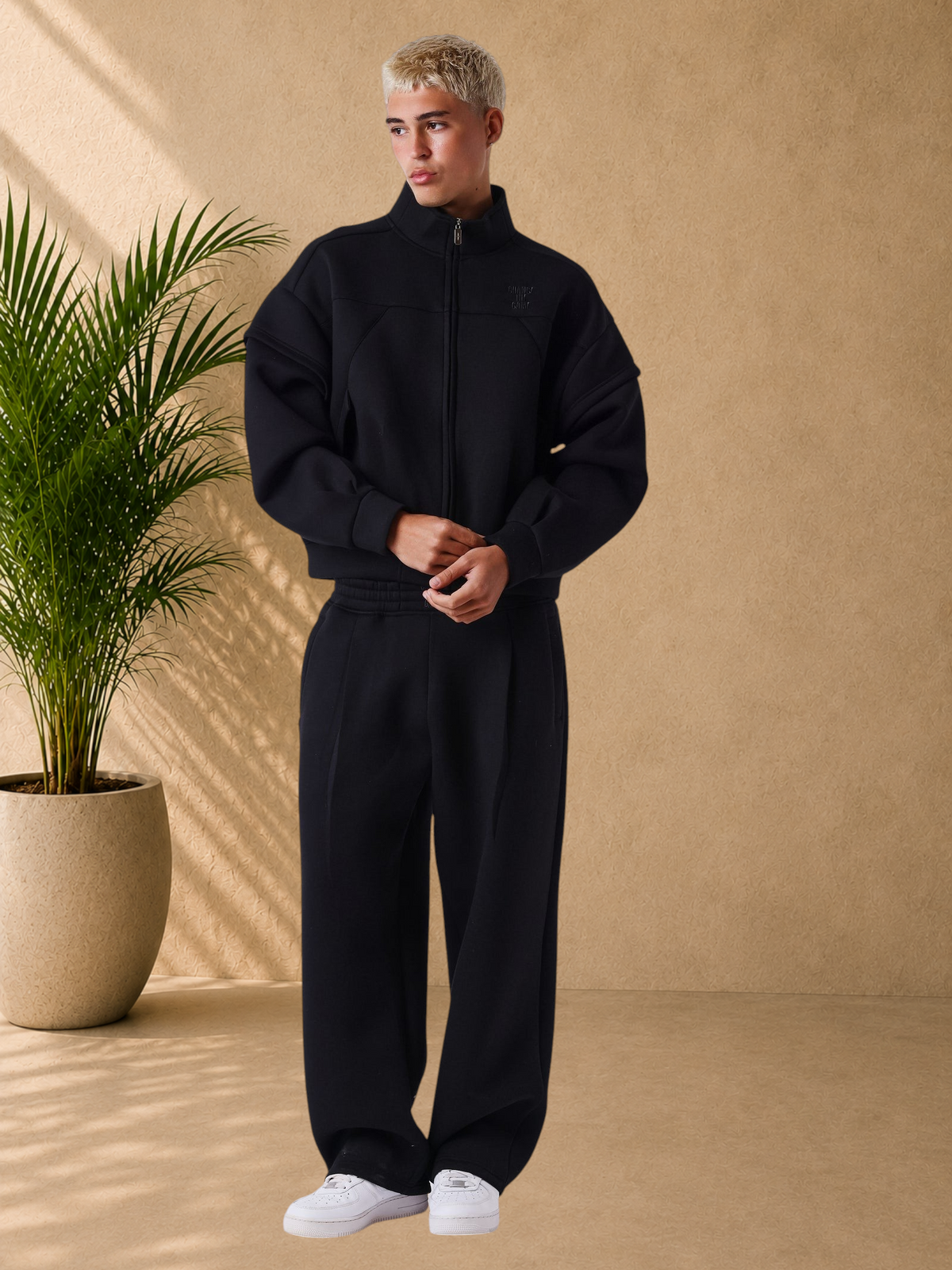 Stayin PXP black neoprene boxy zip-up jacket with high collar and structured panels worn by a male model
