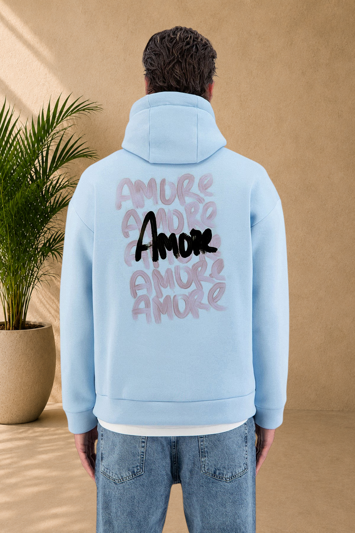 Stayin light blue quilted hoodie with Amore graphic print on the back worn by a model