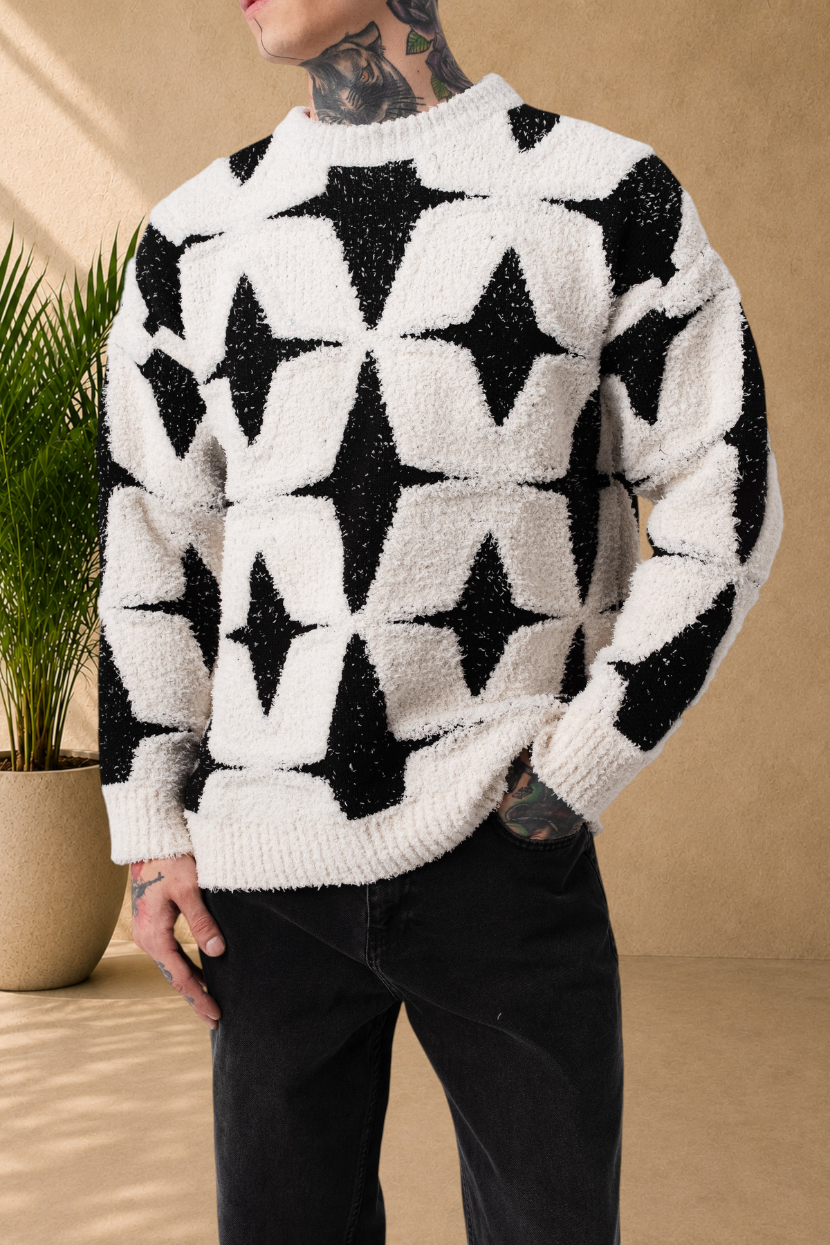 Stayin fluffy sweater featuring a black and white star pattern, round neck, and soft textured knit on a male model.