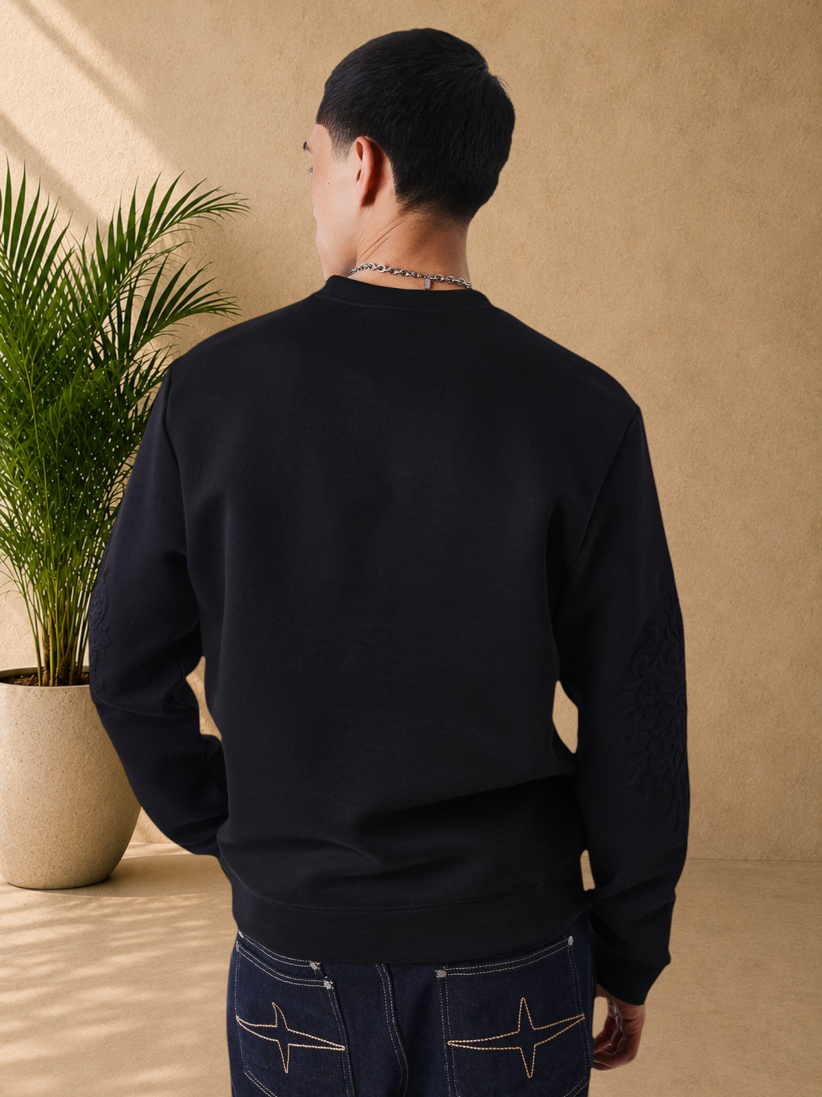 Stayin PXP black regular fit sweatshirt with crew neck and embossed sleeve details worn by a man from the back
