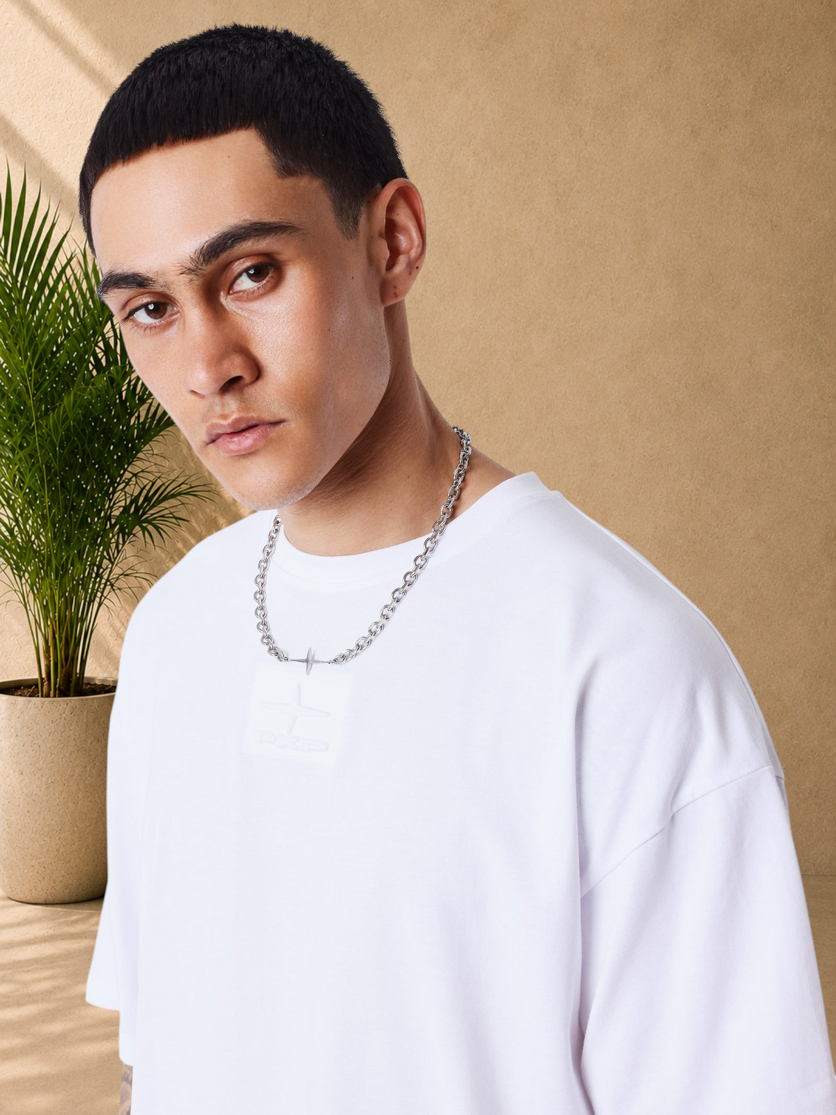 Stayin white boxy fit cotton t-shirt with tonal embossed chest logo worn by a model with a silver chain necklace