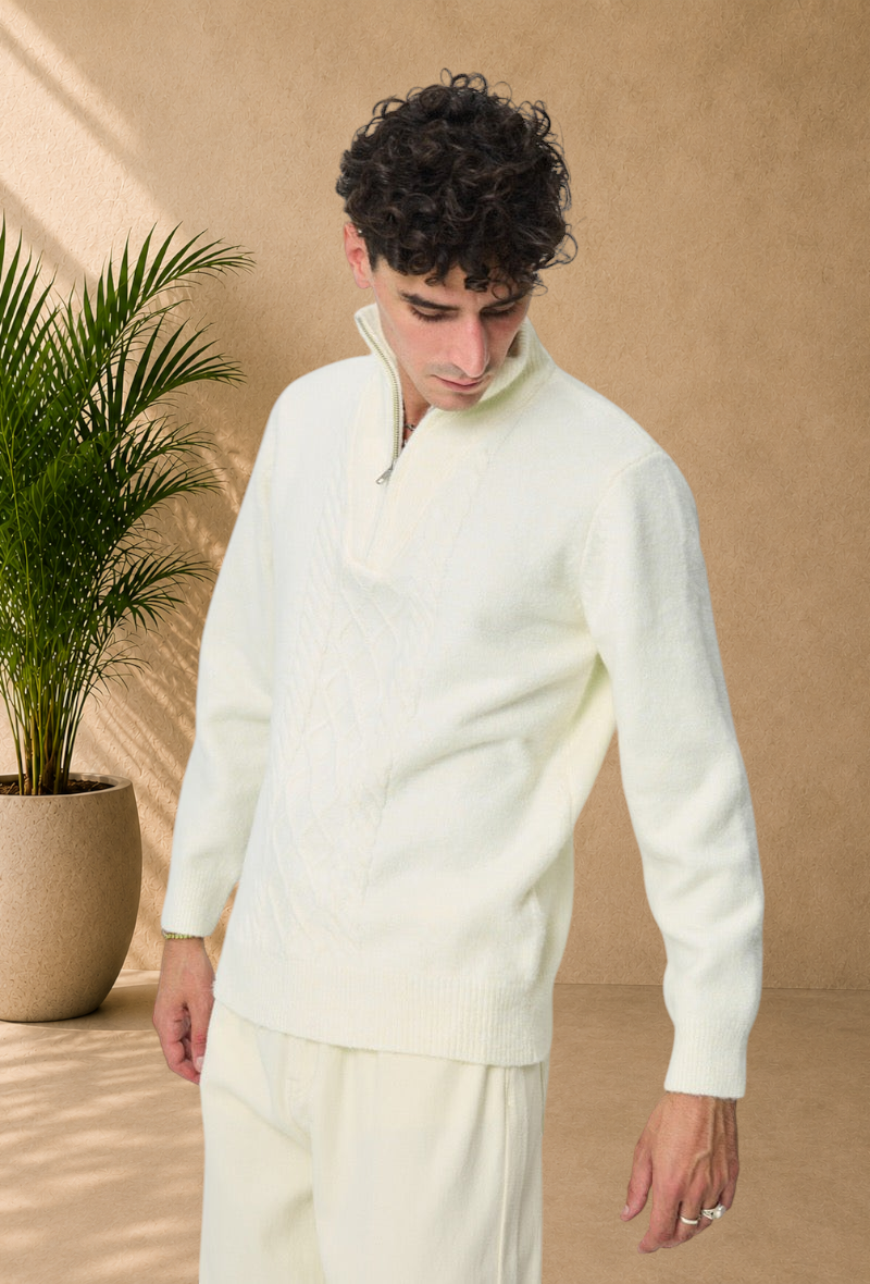 Stayin white cable knit sweater with a zip-up mock neck worn by a model against a plain background