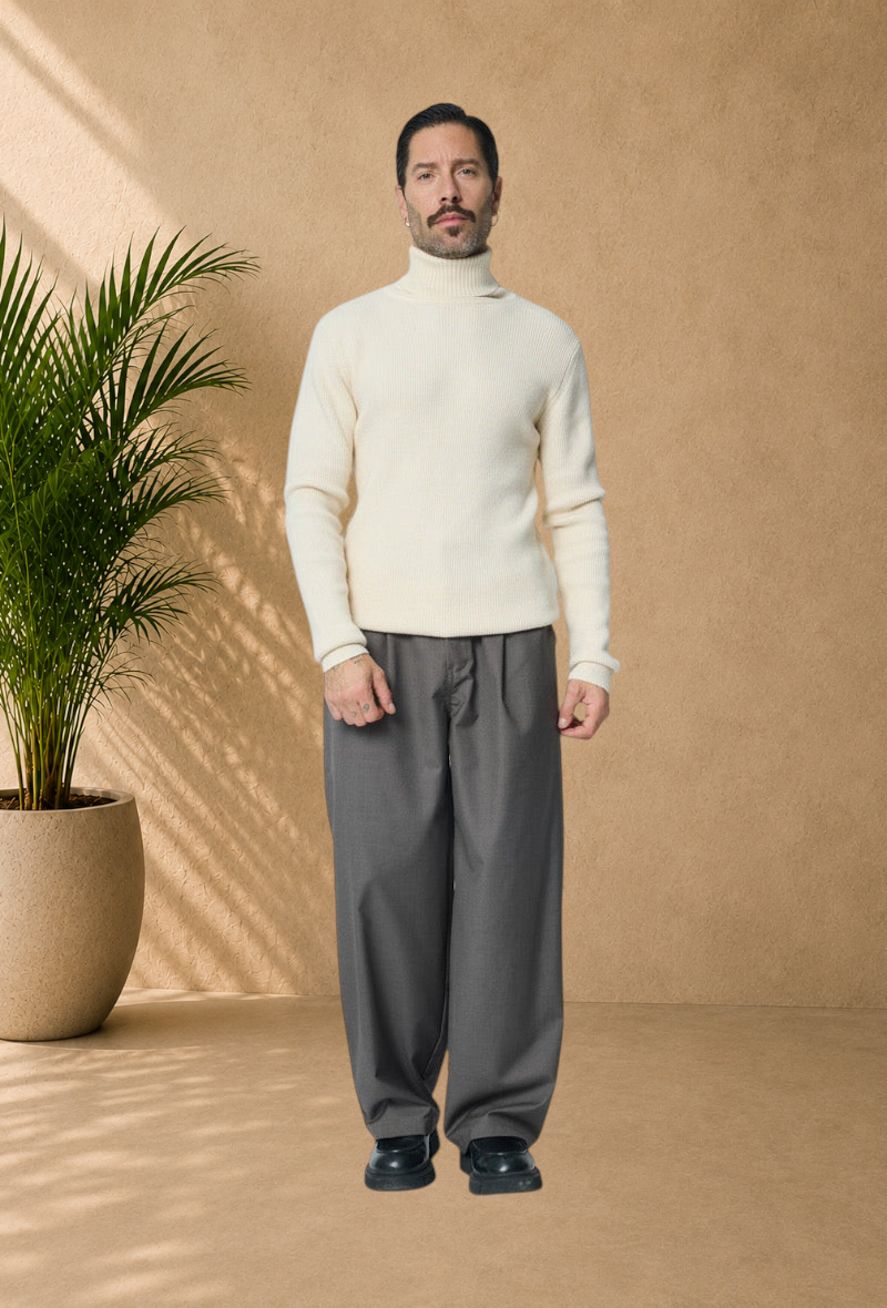 Stayin ivory ribbed turtleneck sweater worn by a man with grey trousers and black shoes