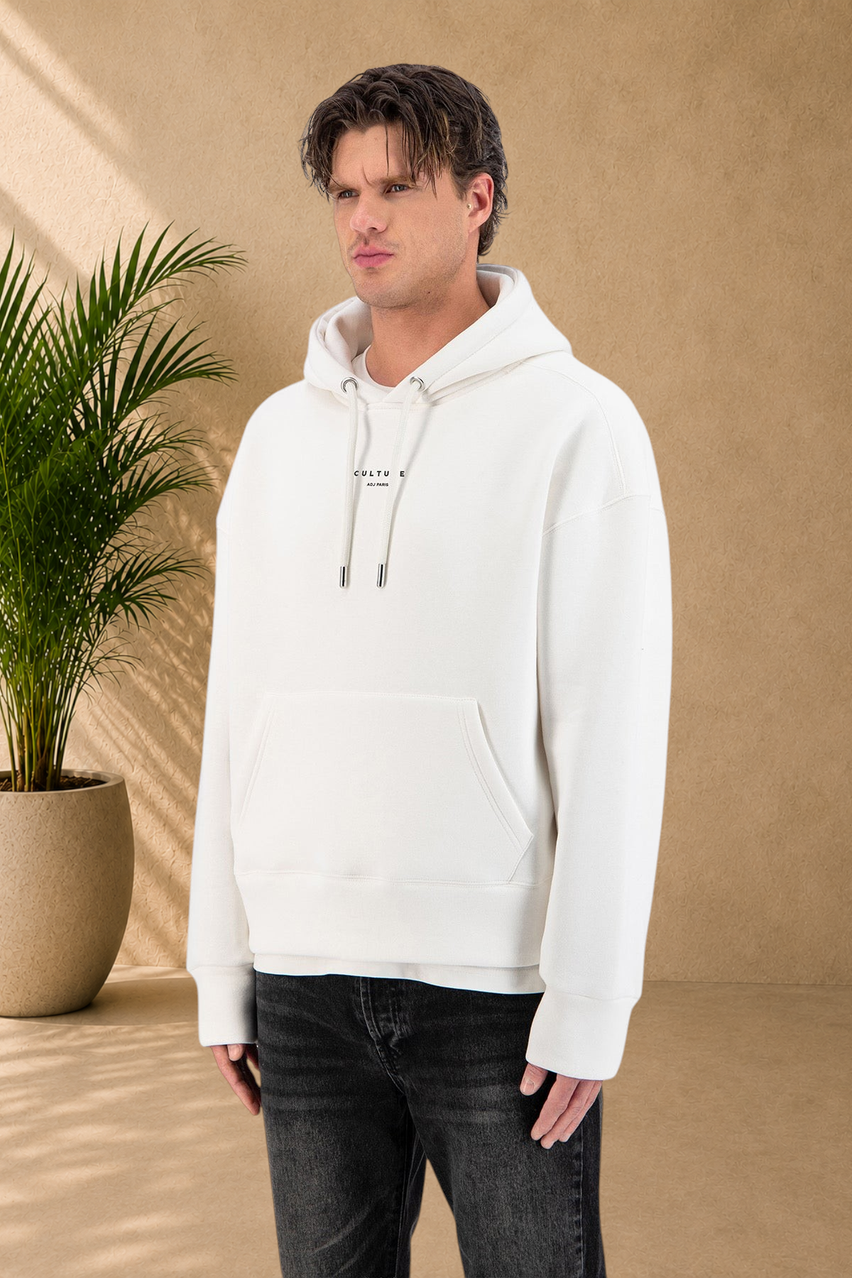 Stayin white Culture hoodie with thick quilted fabric and drawstring hood worn by a male model