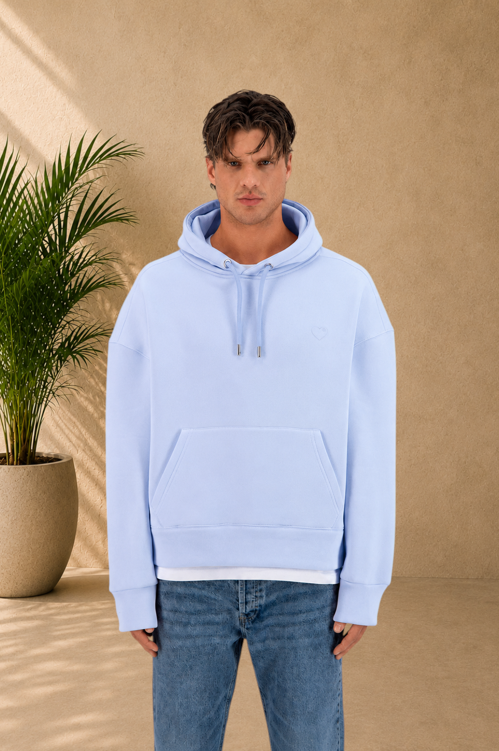 Stayin light blue quilted hoodie with a small heart detail worn by a male model against a neutral background