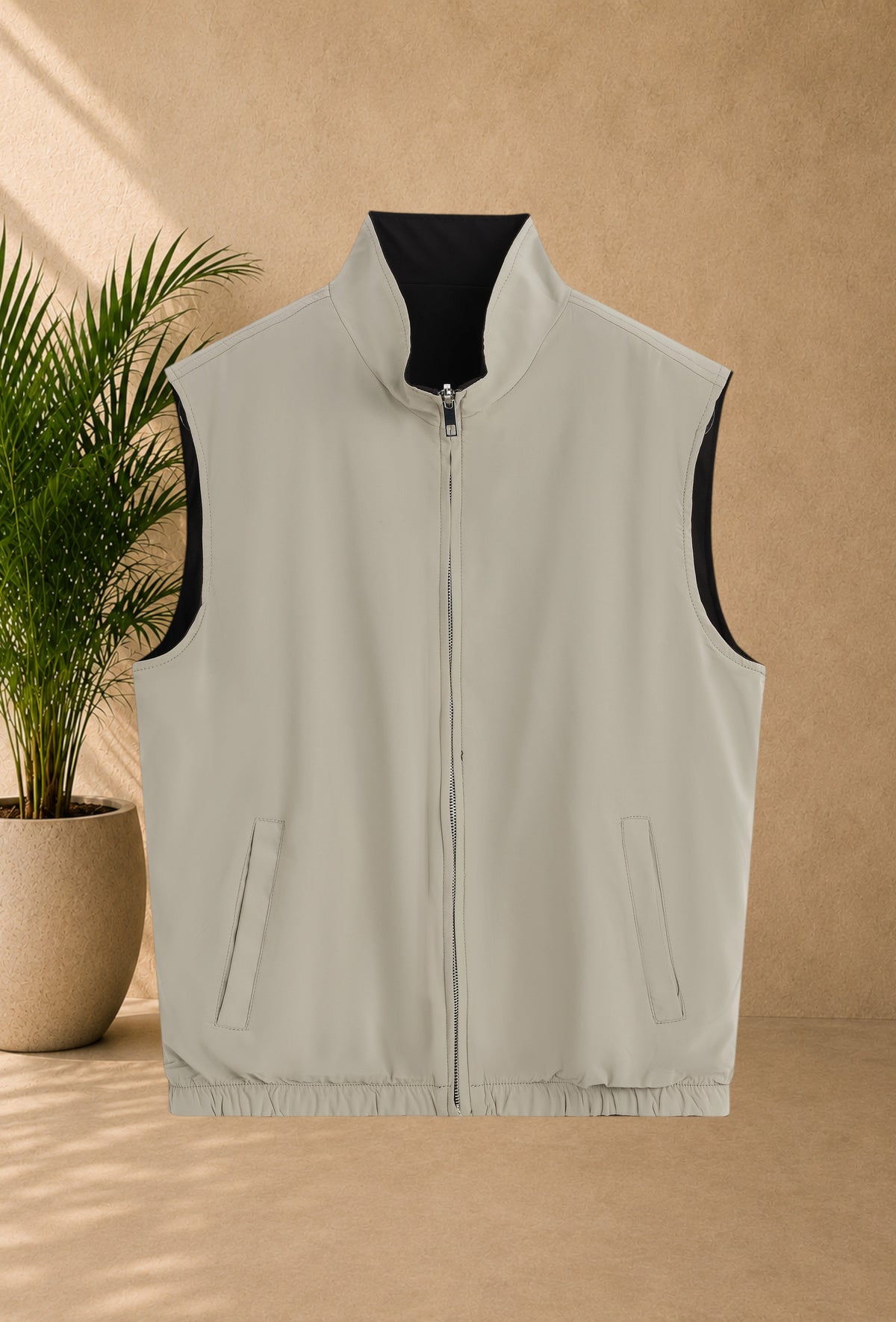 Stayin reversible sleeveless zip-up vest in beige and black with a modern straight cut and high collar