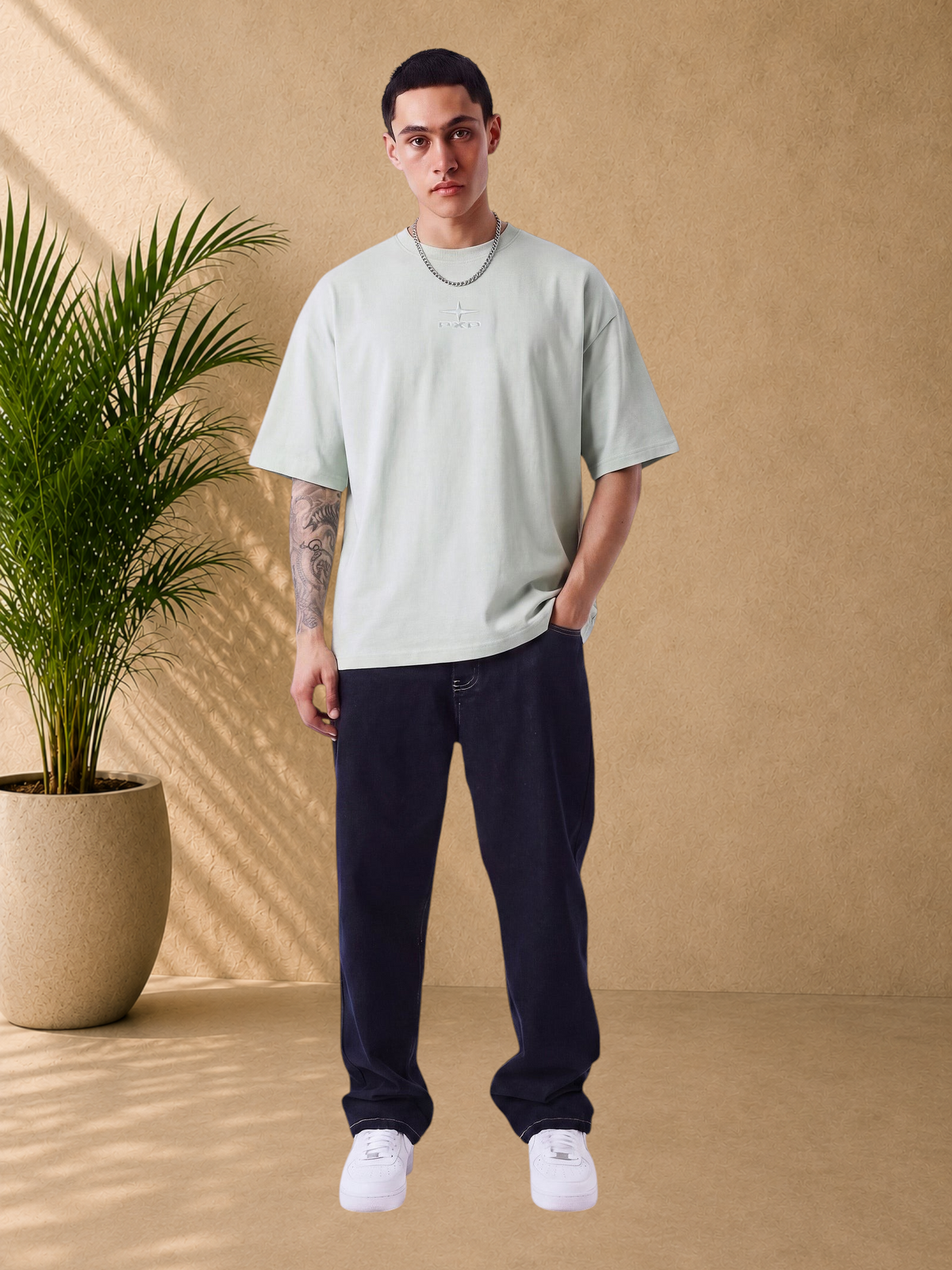 Stayin mint green boxy fit cotton t-shirt with embossed logo on chest worn by a male model