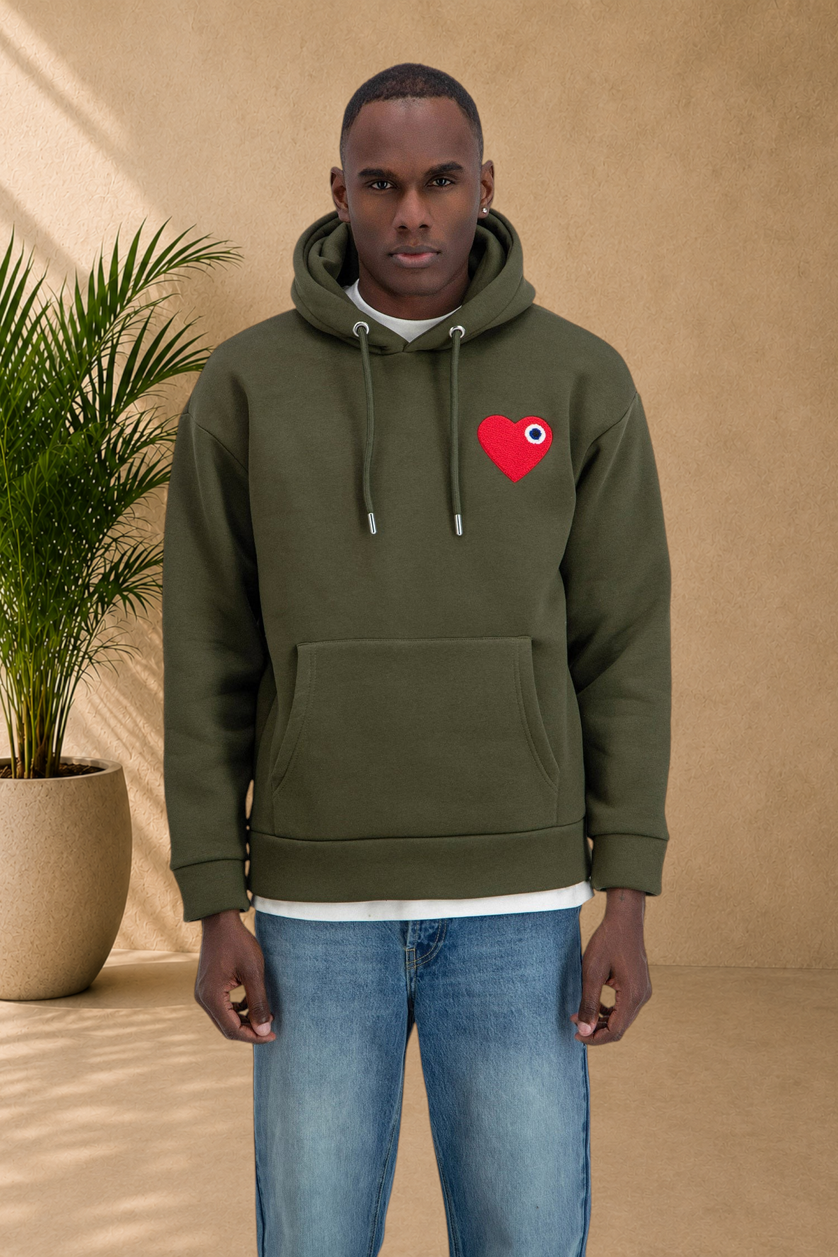 Stayin khaki quilted hoodie with a red heart patch on the chest worn by a male model