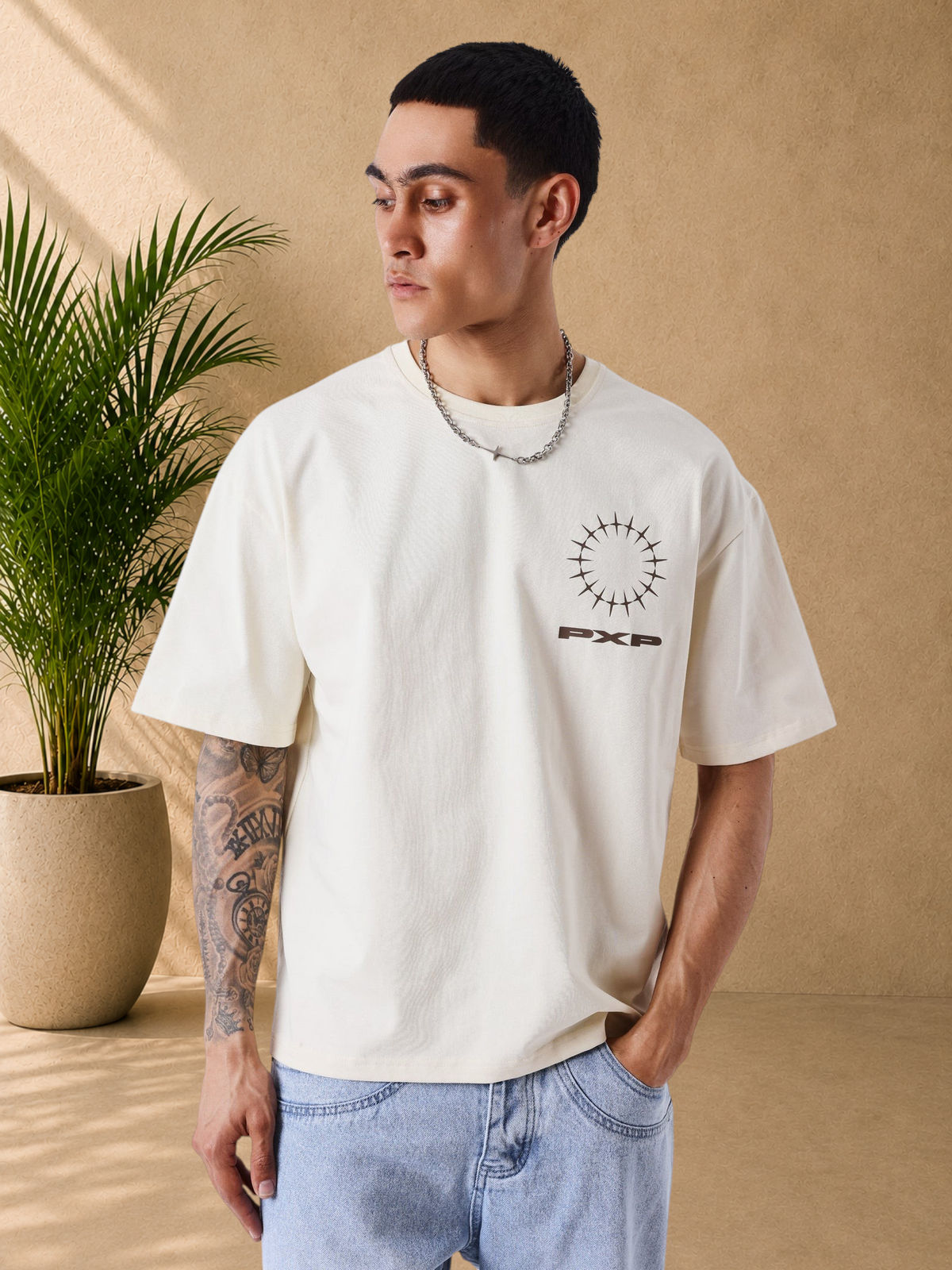 Stayin PXP beige oversized cotton t-shirt with front graphic logo print worn by a model