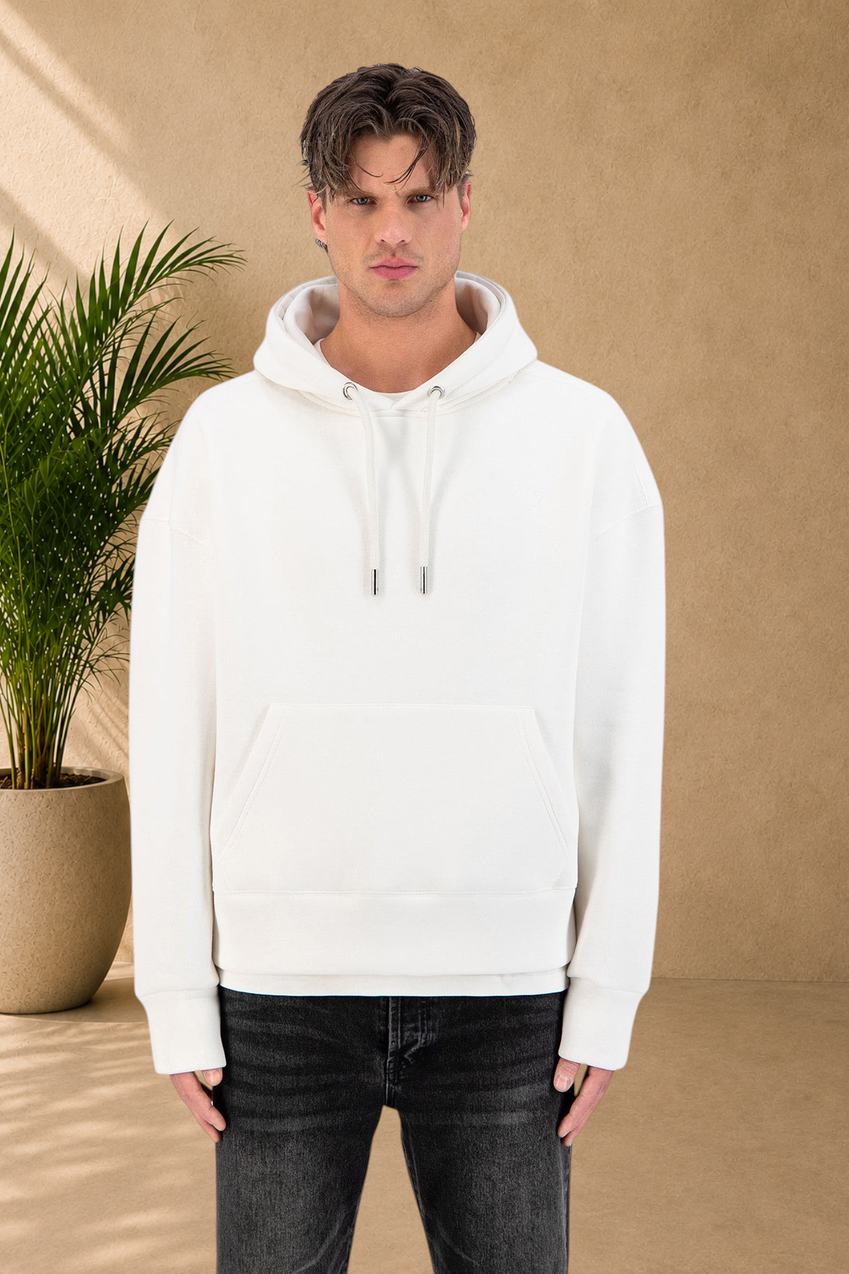 Stayin white quilted hoodie with a small heart detail worn by a male model against a white background
