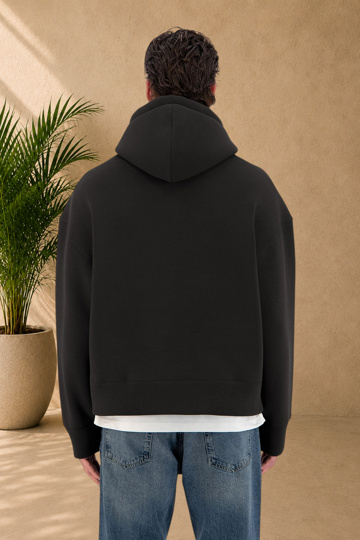 Stayin black quilted hoodie worn by a model, back view showing thick fabric and relaxed fit