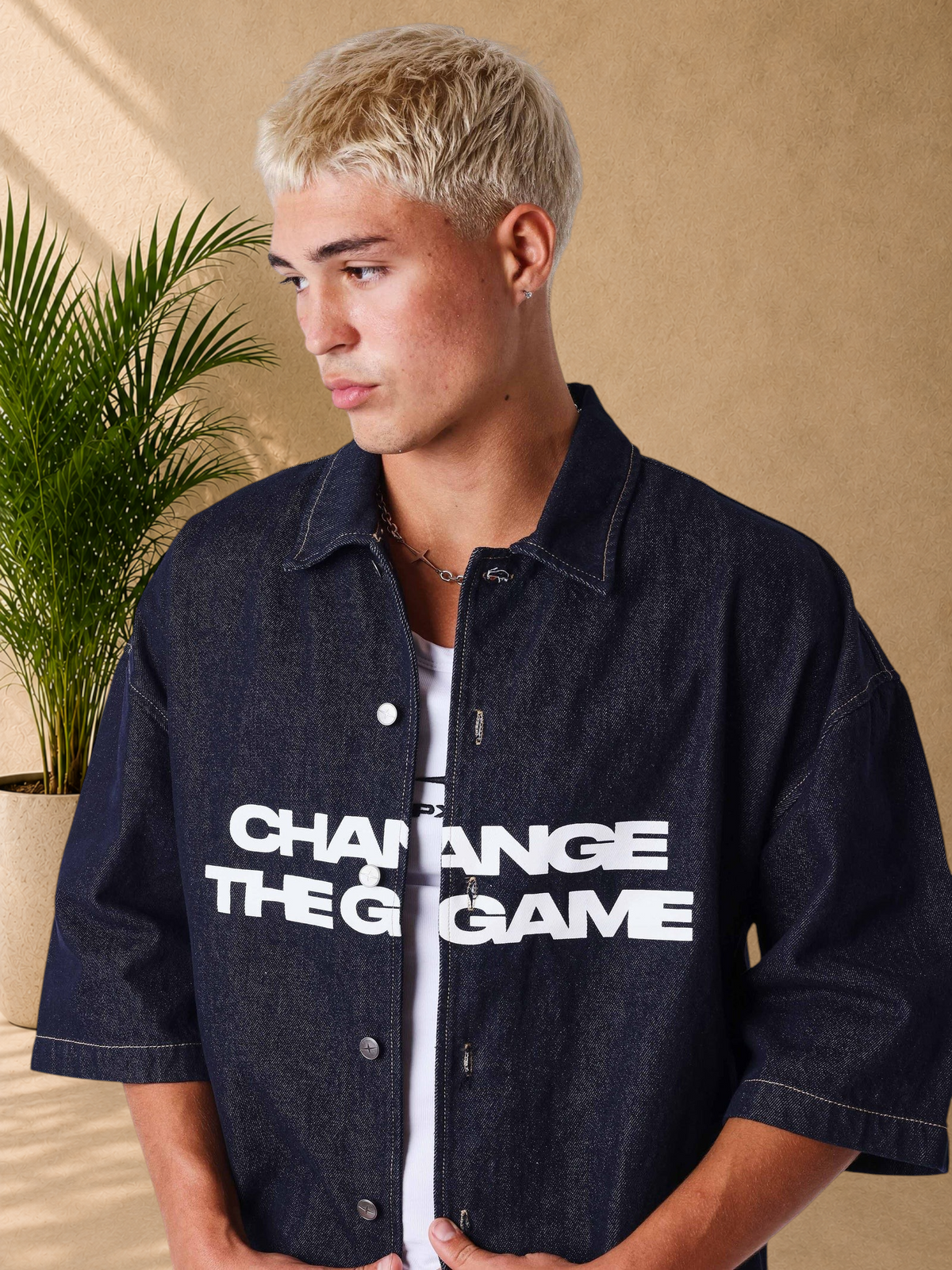 Stayin oversized dark denim short-sleeve shirt with white graphic print worn by a blonde model