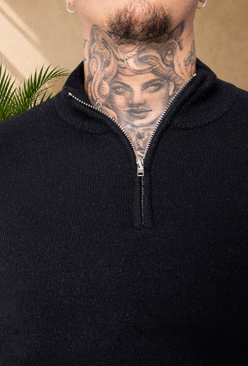 Stayin black knit sweater with a high zip-up collar, featuring a soft texture and modern straight fit.