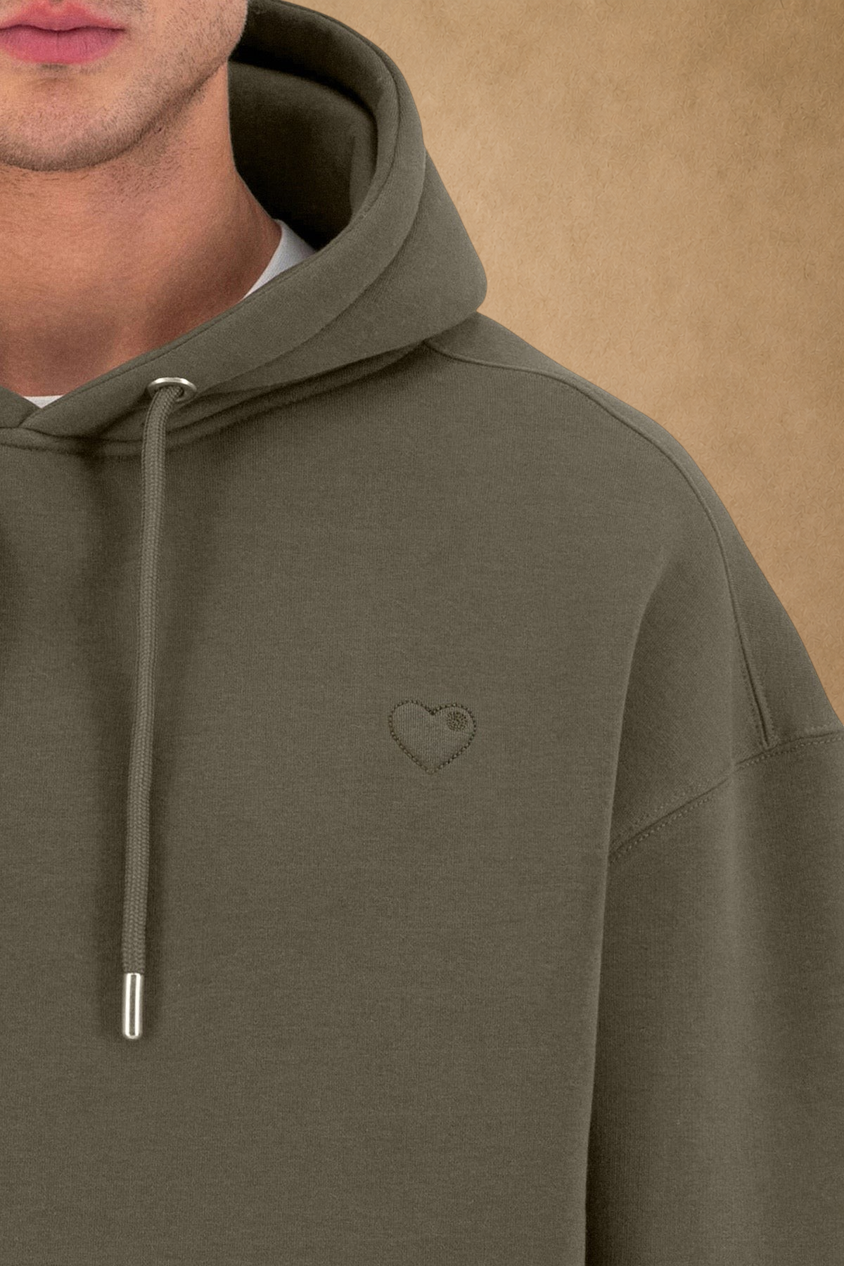 Stayin khaki quilted hoodie with a small embroidered heart detail on the chest worn by a model