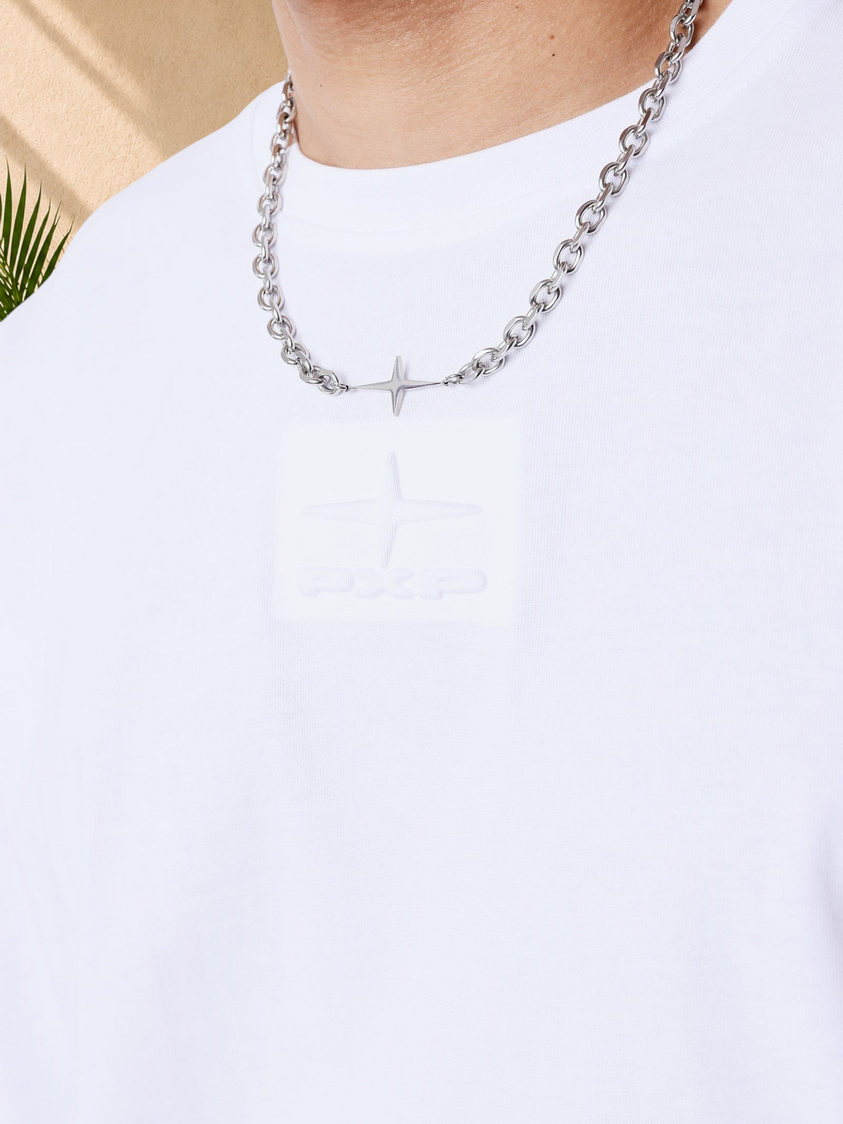 Stayin white boxy cotton t-shirt featuring a tonal embossed PXP logo on the chest and a silver chain necklace