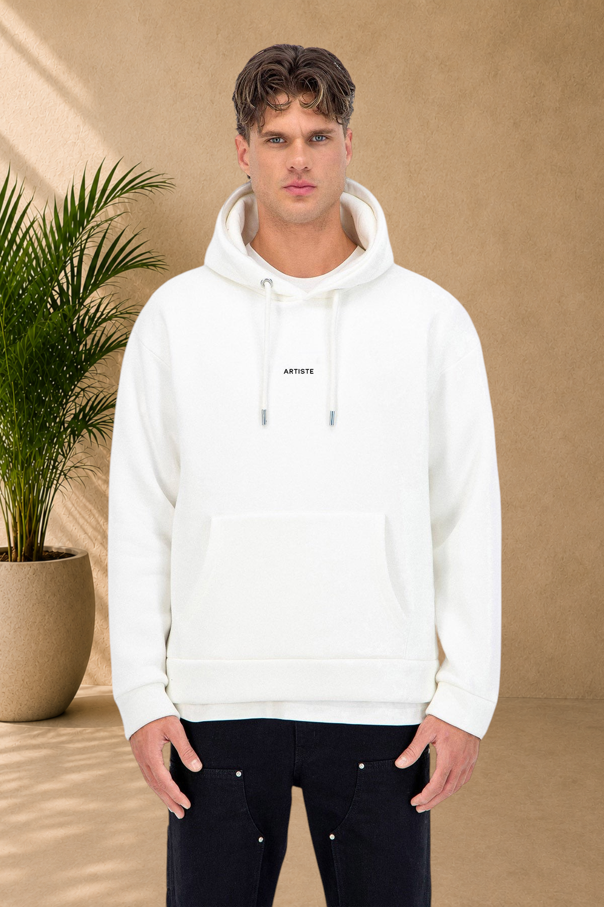 Stayin white quilted hoodie with ARTISTE print worn by a male model on a white background
