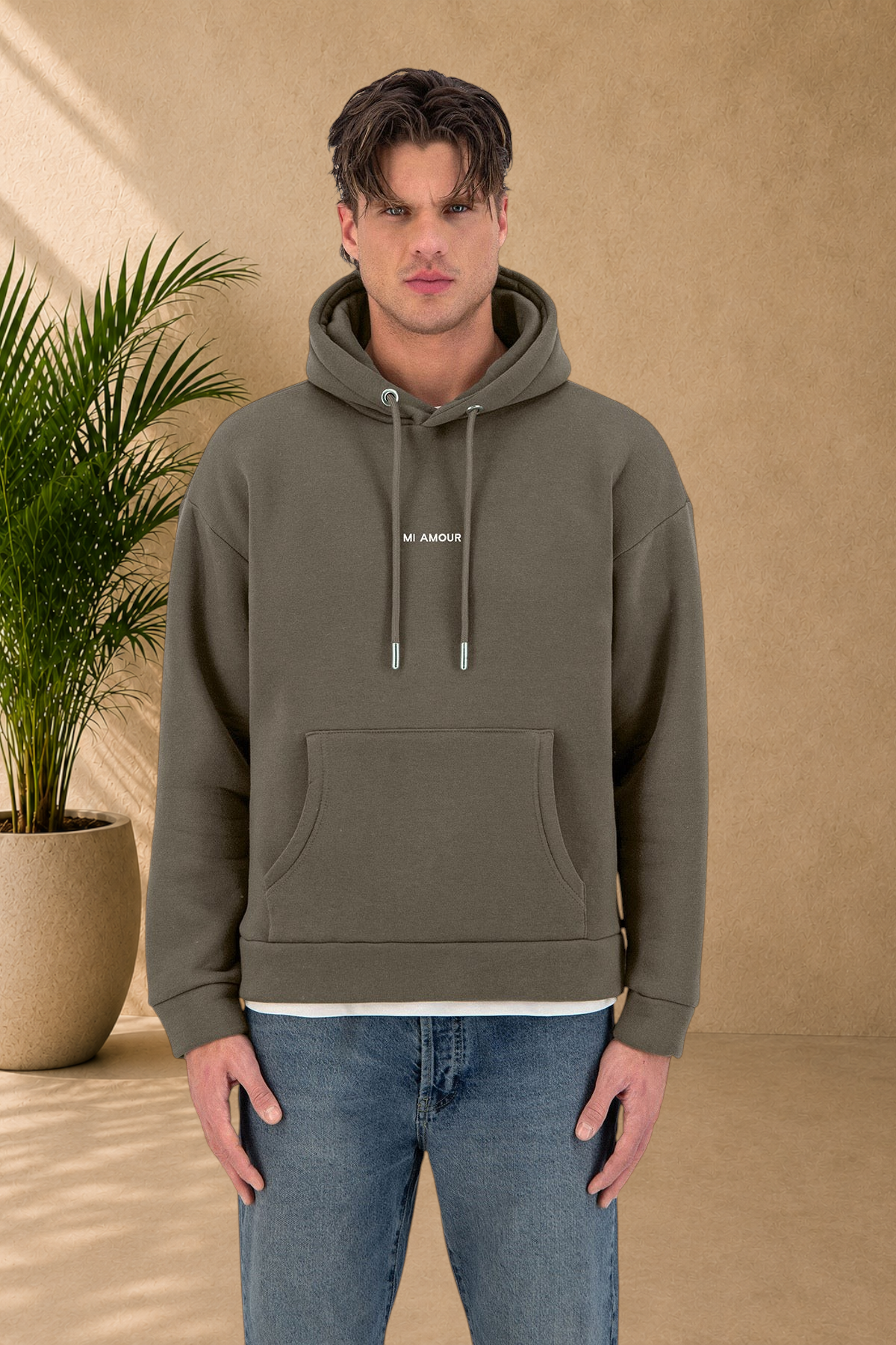 Stayin Amore khaki quilted hoodie with drawstring hood and front pocket worn by a male model