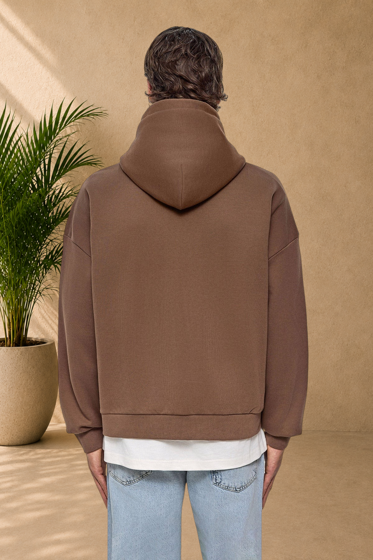 Stayin brown quilted hooded sweatshirt worn by a model, back view showing thick fabric and comfortable fit