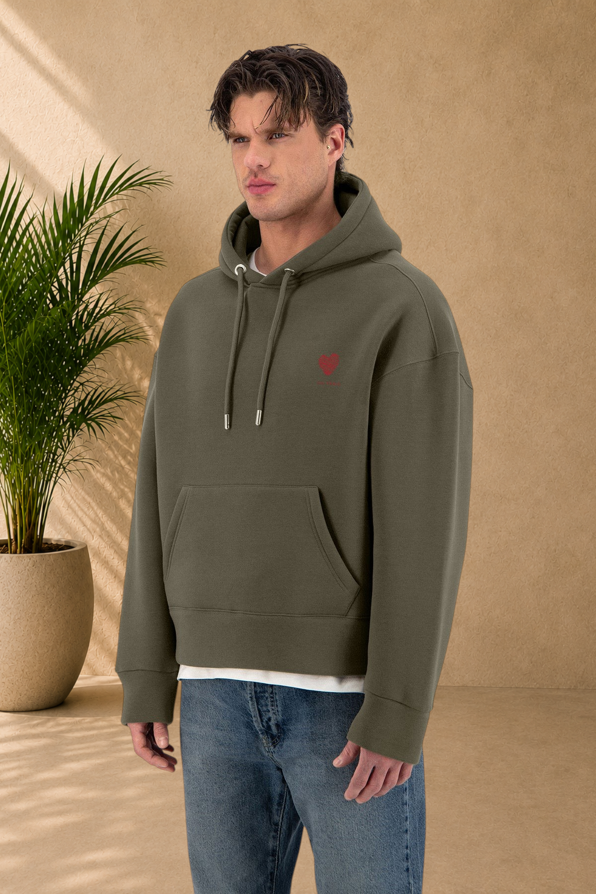 Stayin khaki quilted hoodie with a red heart embroidery on the chest worn by a male model