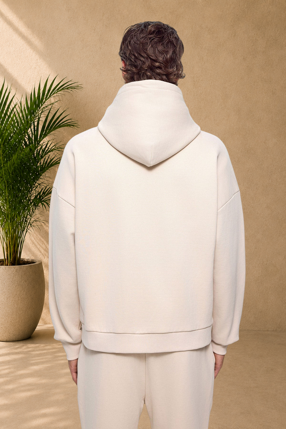 Stayin beige quilted hooded sweatshirt worn by a model, back view showing thick fabric and comfortable fit