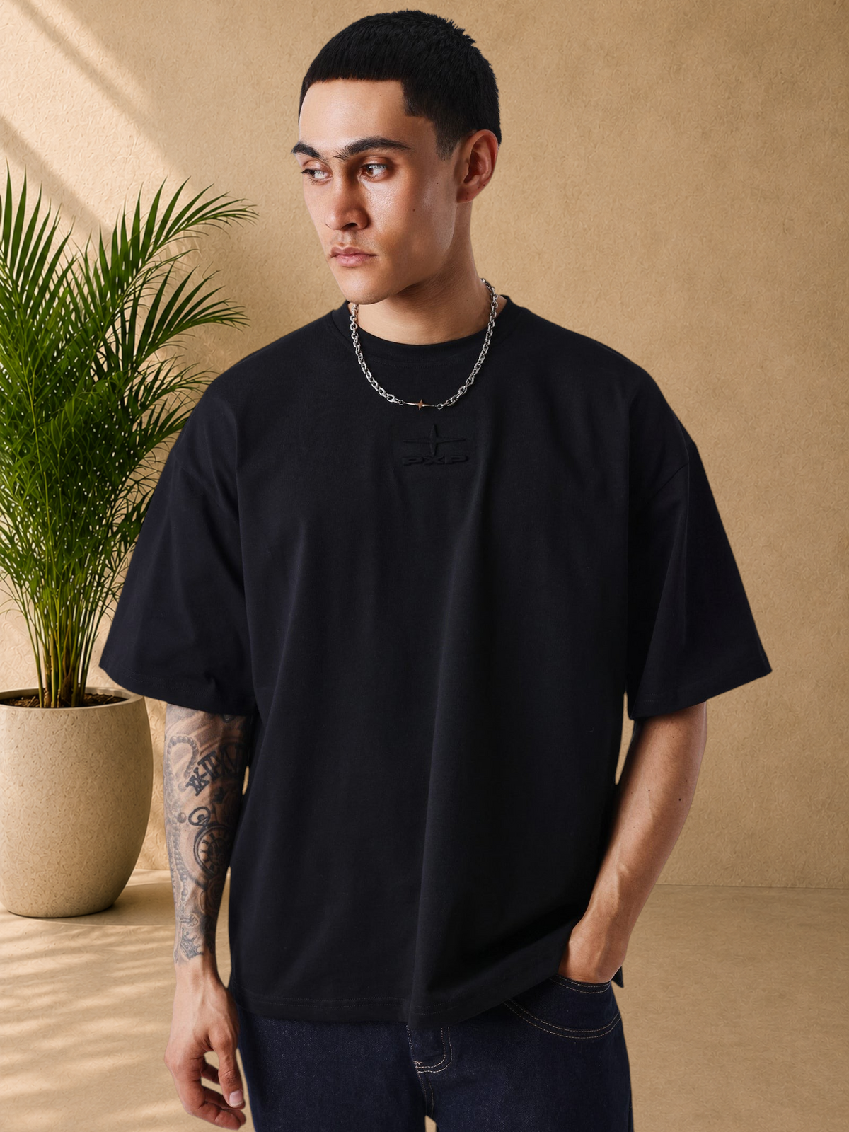 Stayin black boxy fit cotton t-shirt with tonal embossed logo on chest worn by a model