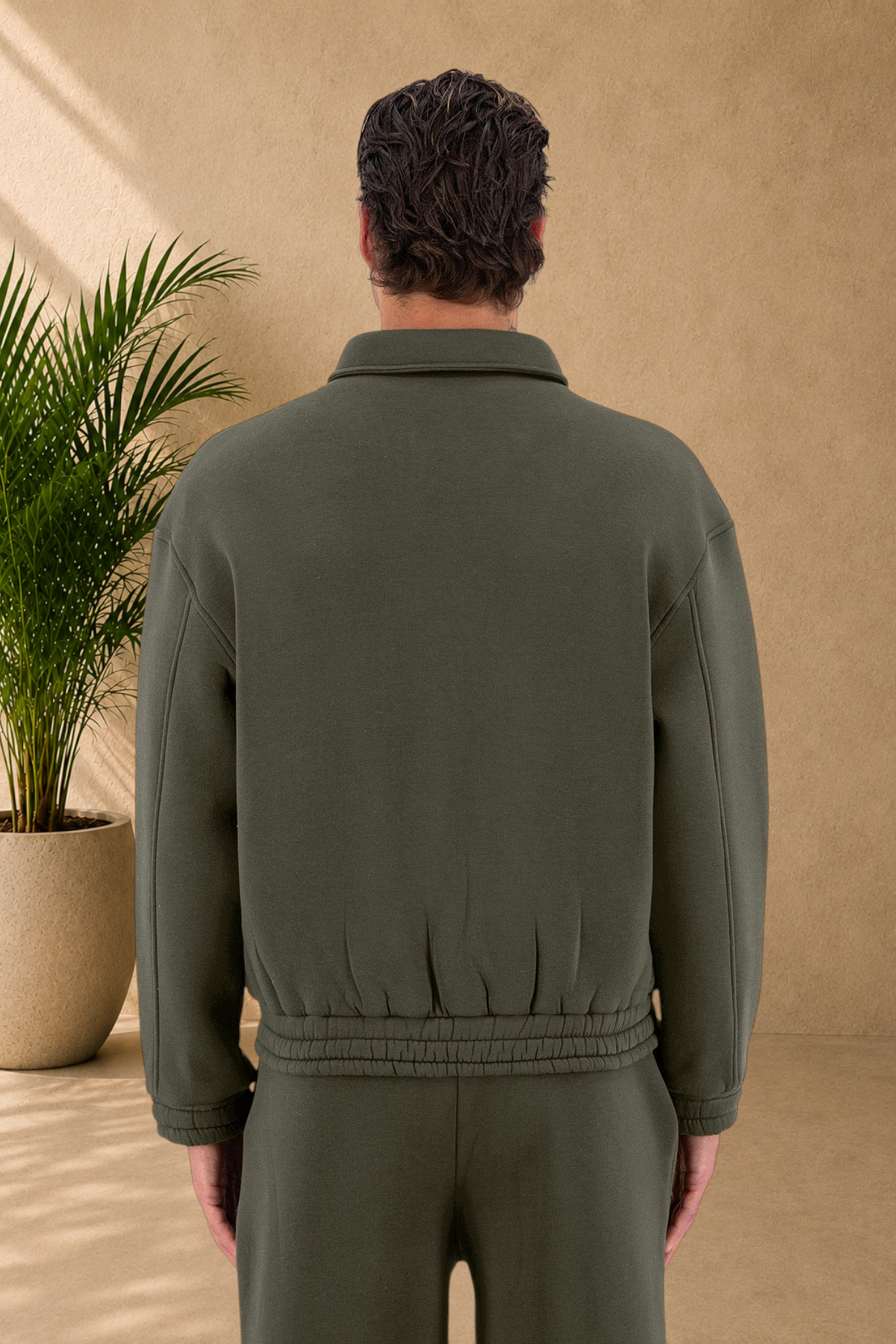 Stayin khaki oversized padded jacket with a collar and ribbed hem, back view on a model