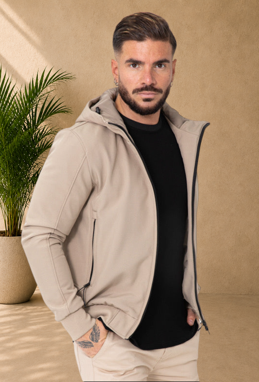 Stayin beige hooded windbreaker jacket with black zipper details worn by a male model