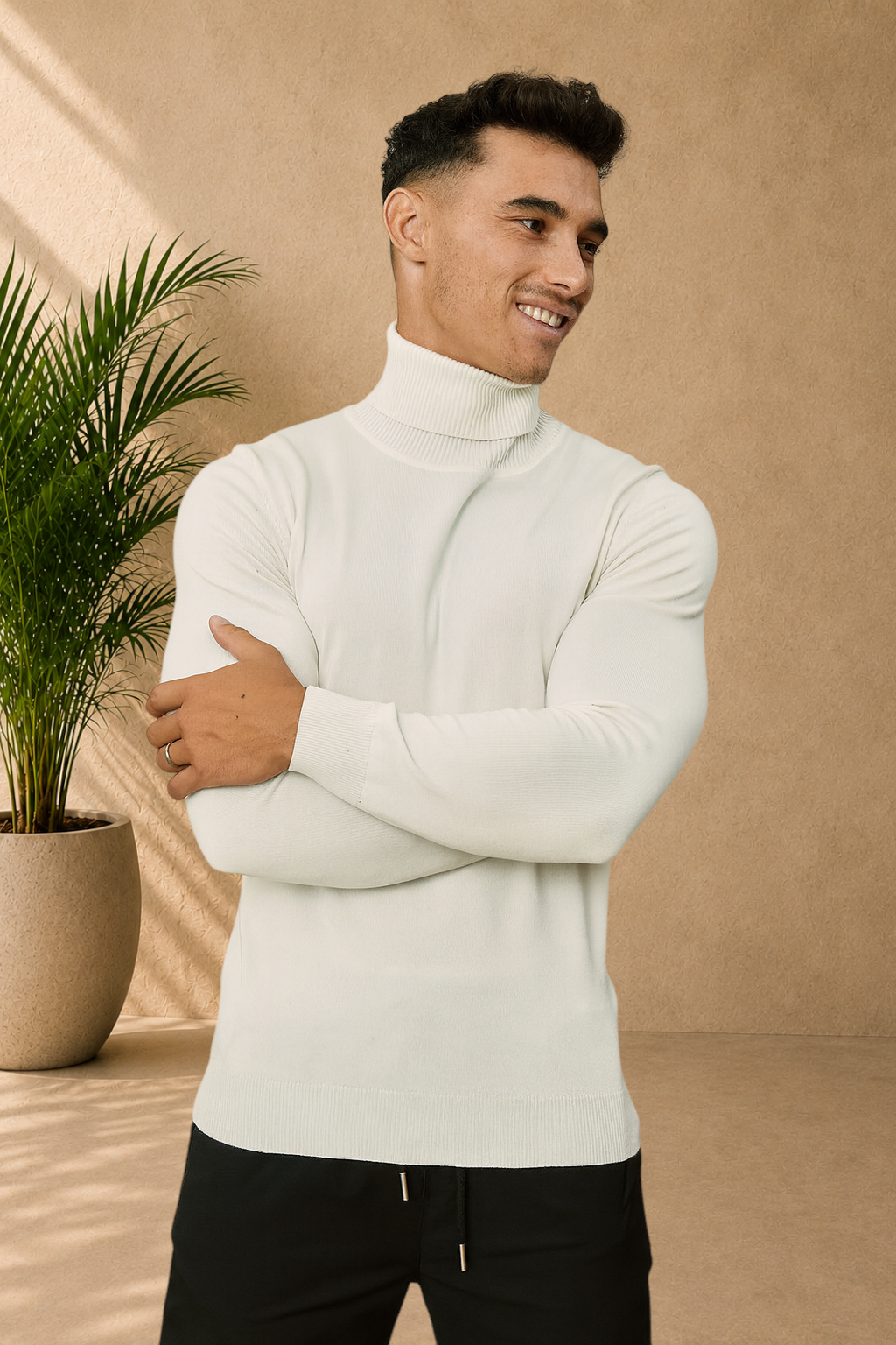 Stayin white slim-fit turtleneck sweater worn by a smiling male model with arms crossed