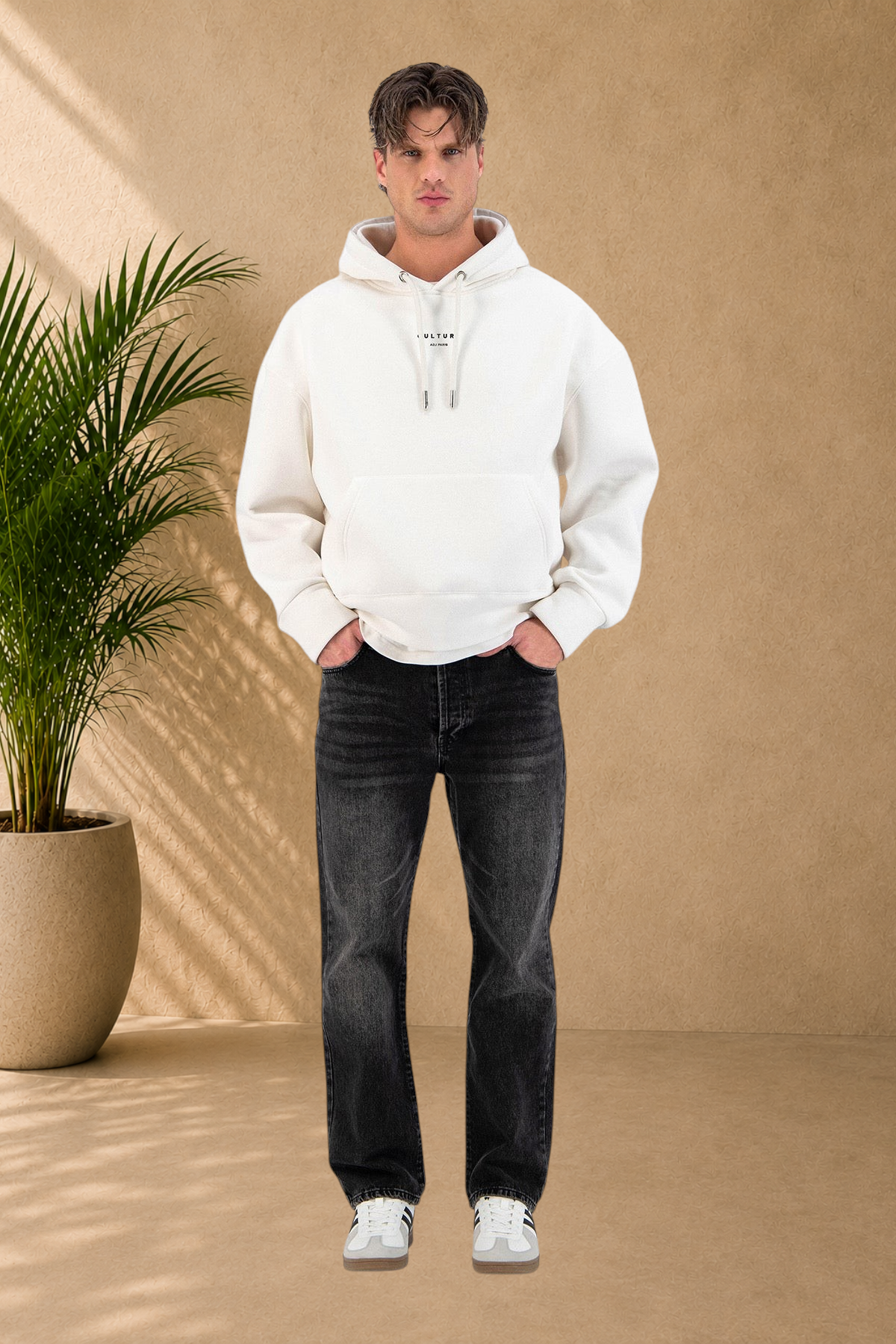 Stayin white quilted hoodie with drawstring hood worn by a male model with black jeans and sneakers