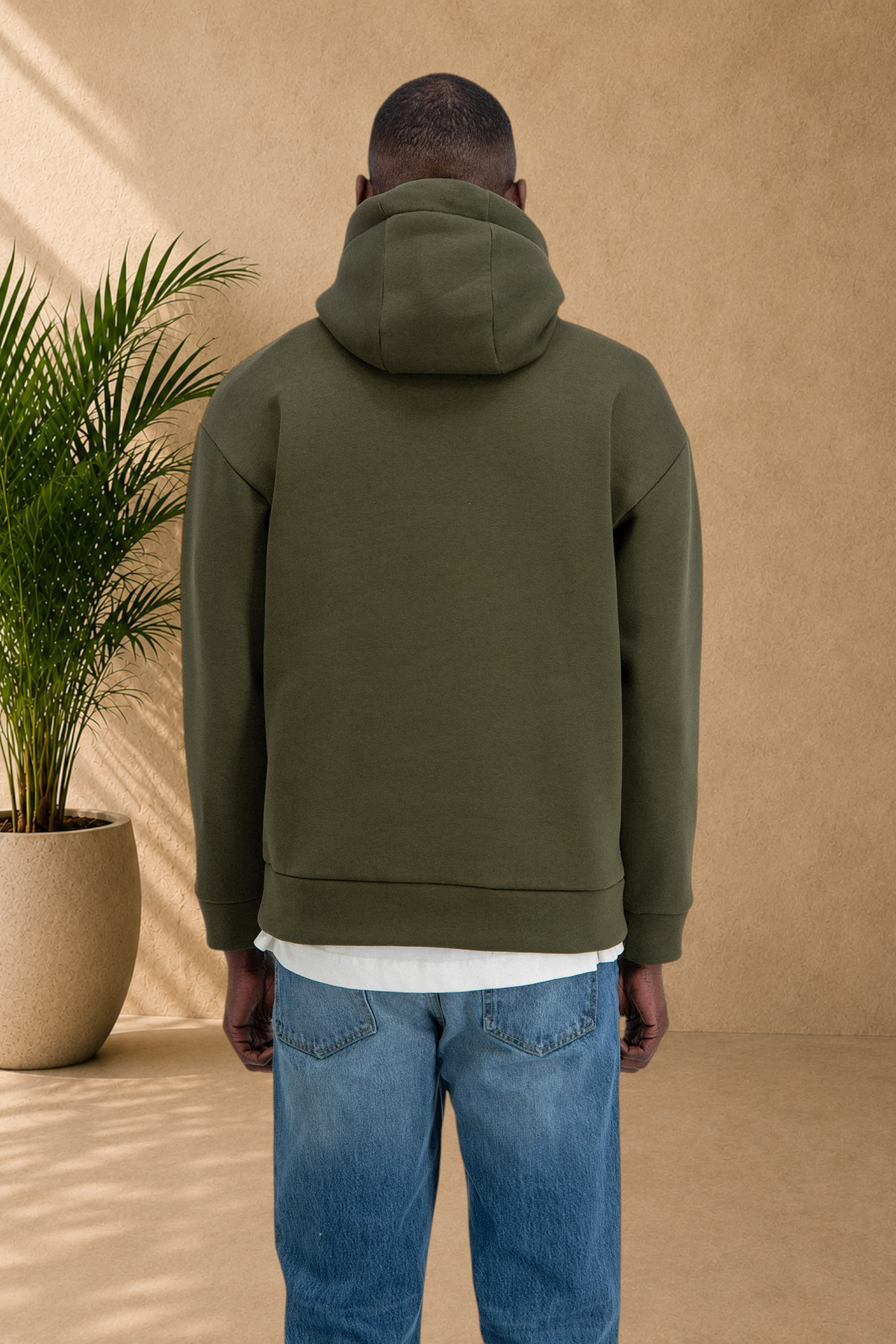 Stayin khaki quilted hoodie worn by a model, back view showing thick fabric and comfortable fit.